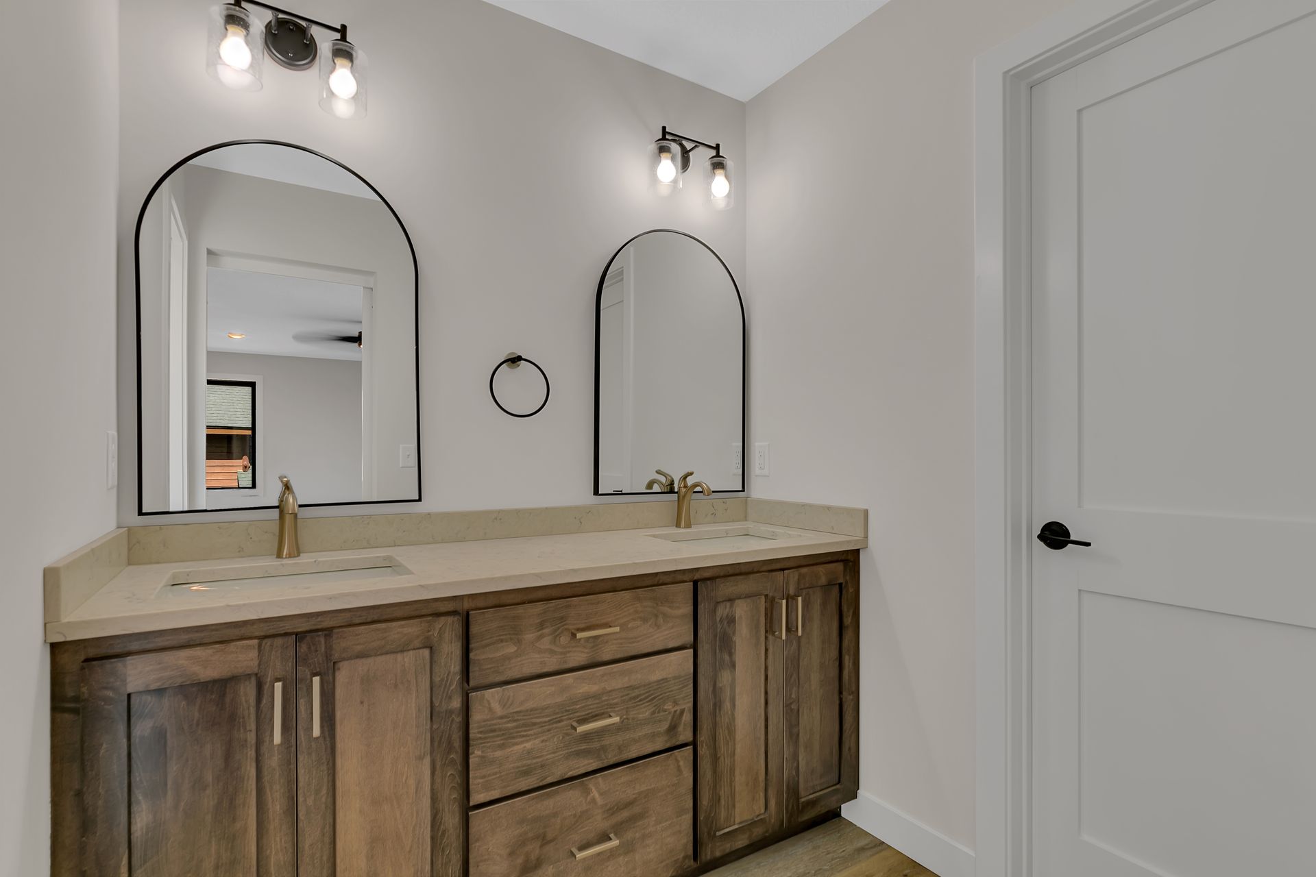 A bathroom with two sinks and two mirrors.