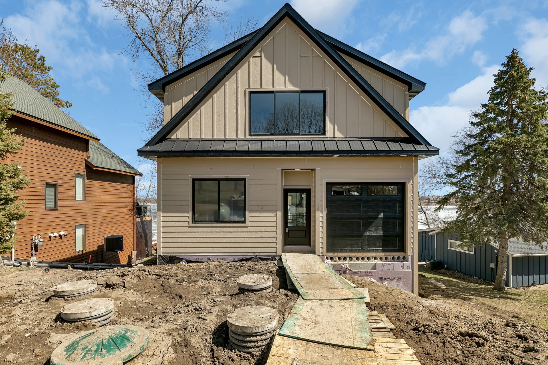 A house is being built in the middle of a dirt field.