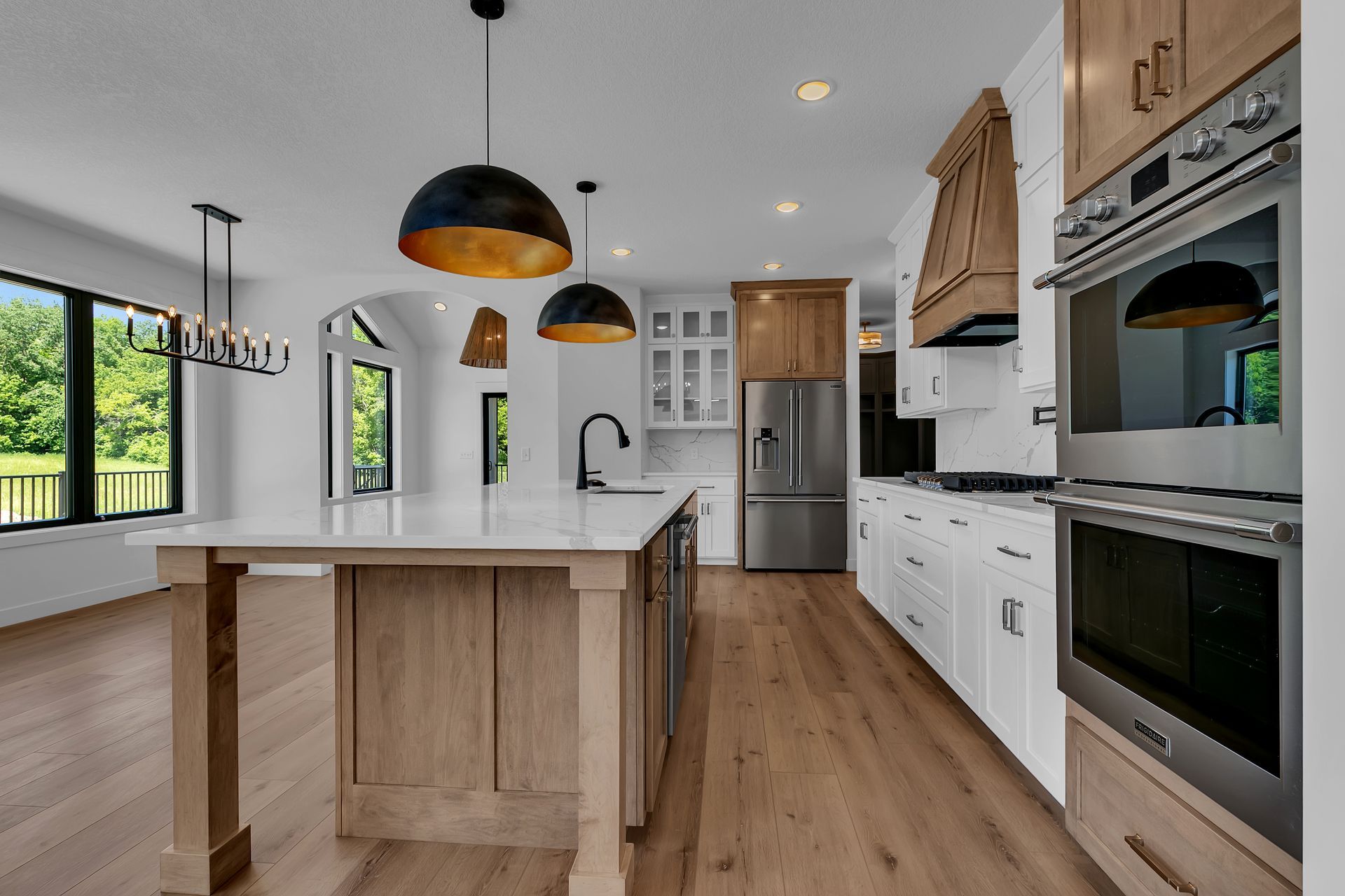 A kitchen with a large island and stainless steel appliances.