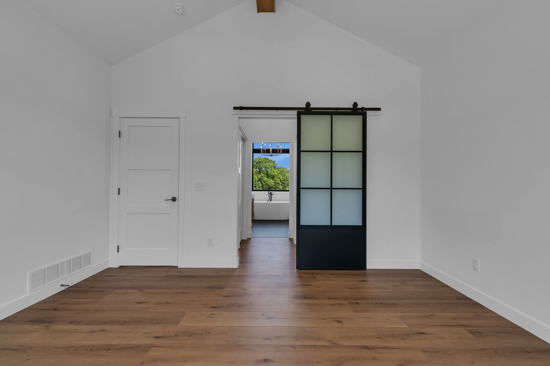 There is a sliding barn door in the middle of the room.