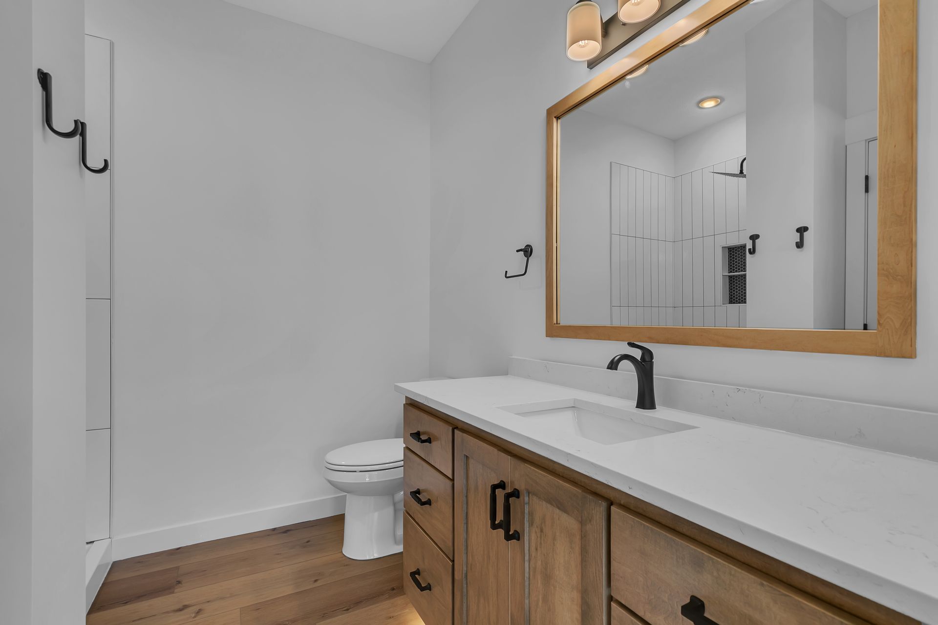 A bathroom with a toilet , sink and mirror.
