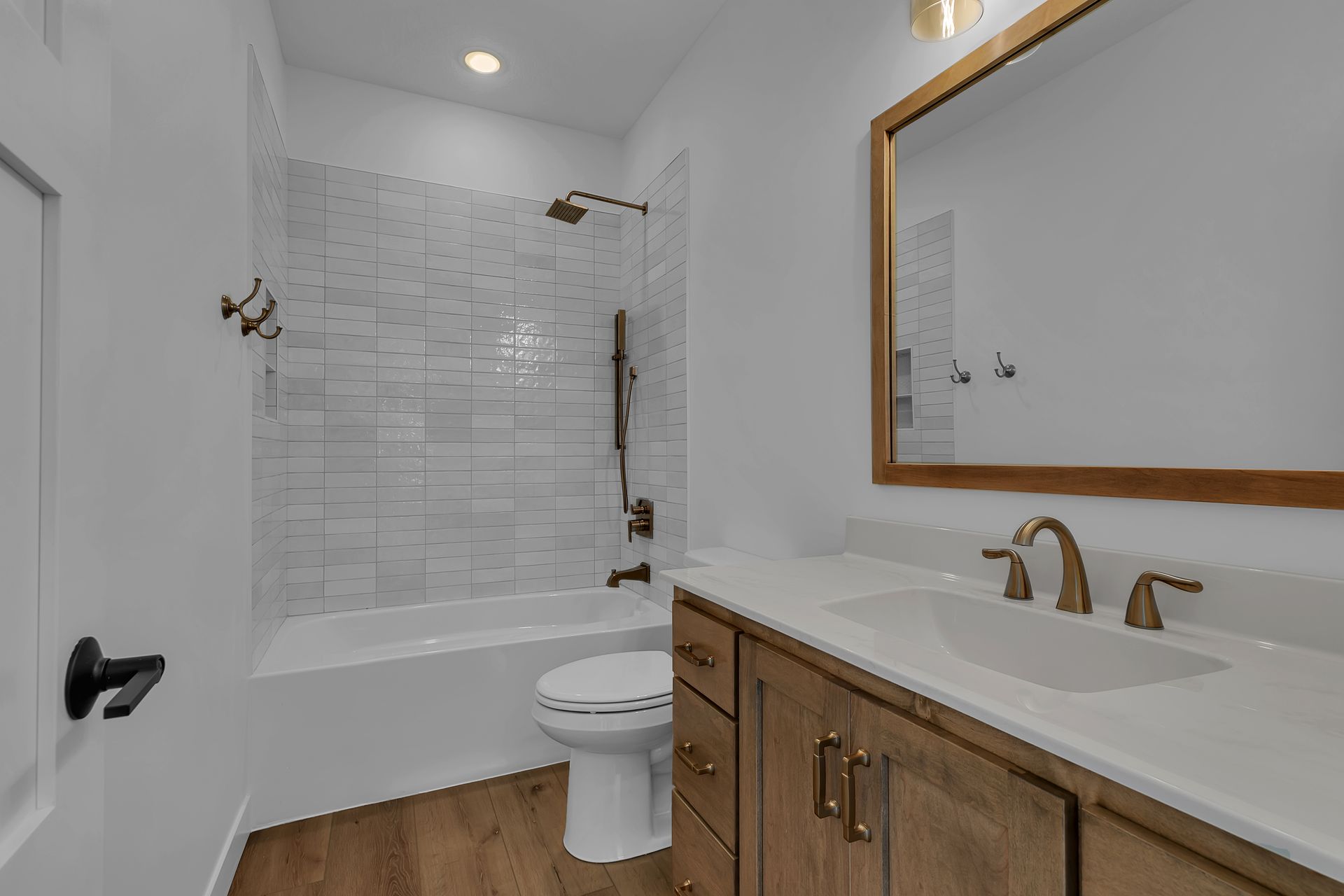 A bathroom with a toilet , sink , and mirror.