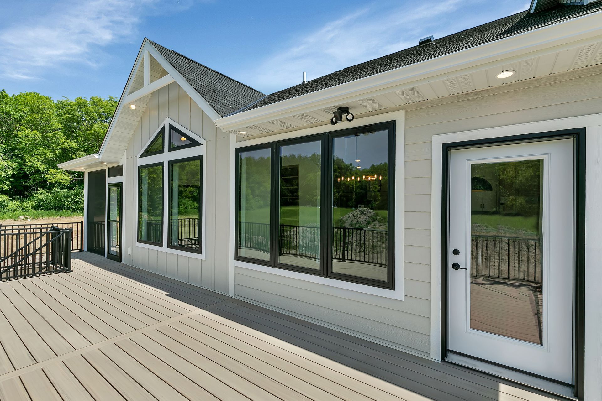 A house with a large deck and a lot of windows