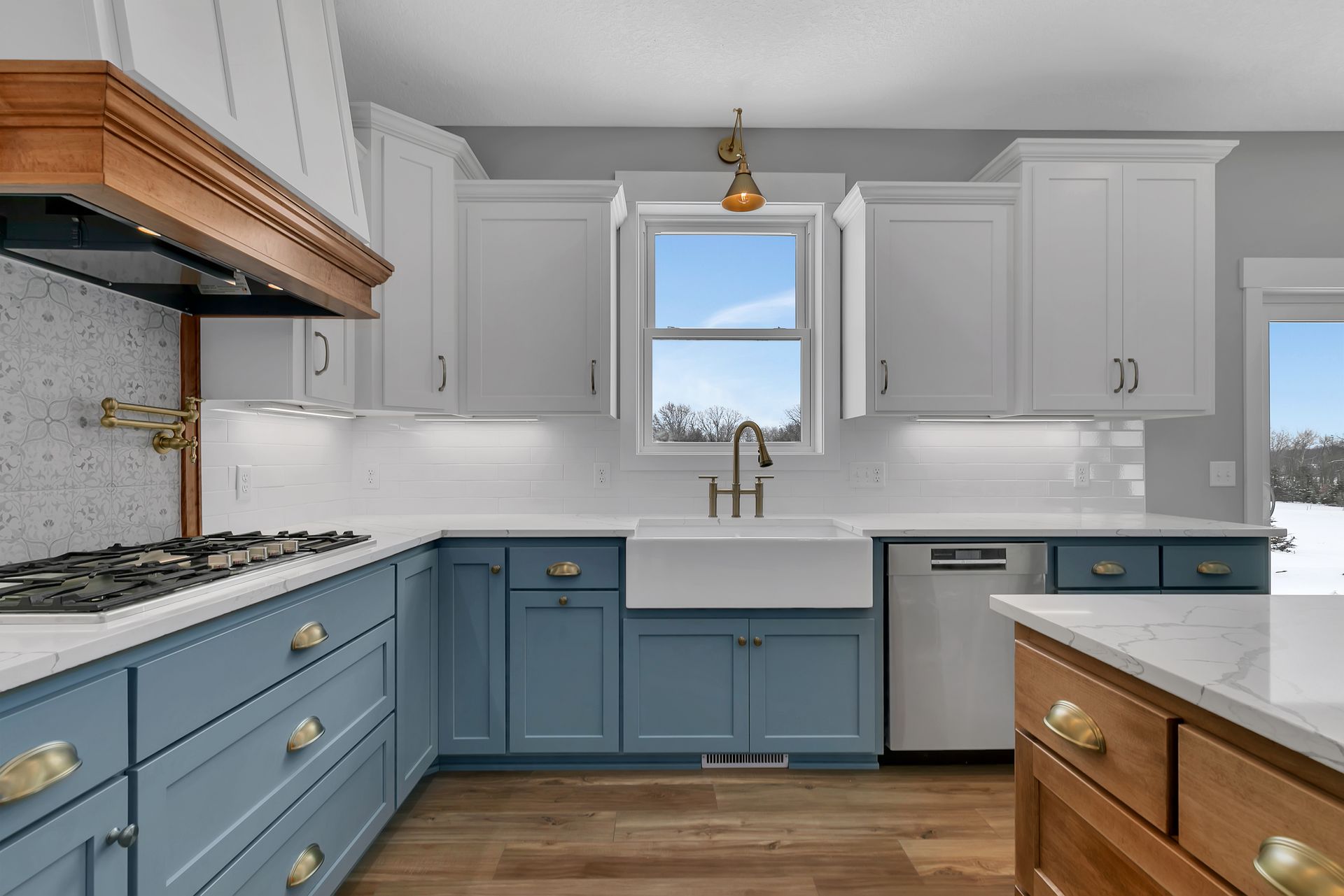 A kitchen with blue cabinets and white counter tops