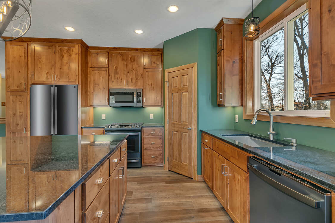 A kitchen with wooden cabinets and granite counter tops