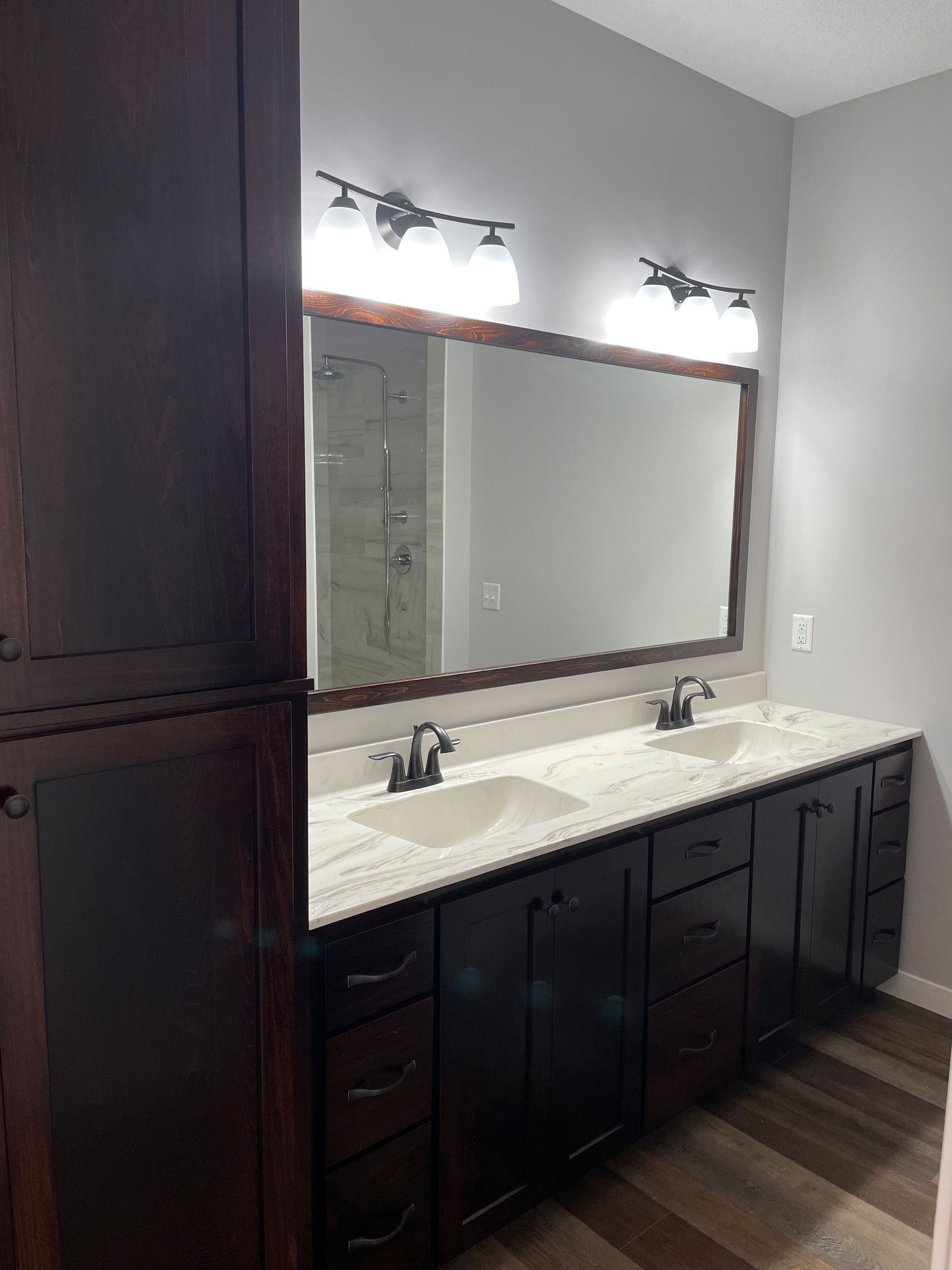 A bathroom with two sinks and a large mirror.