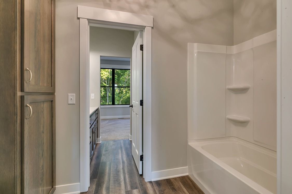 A bathroom with a bathtub and a walk in shower.