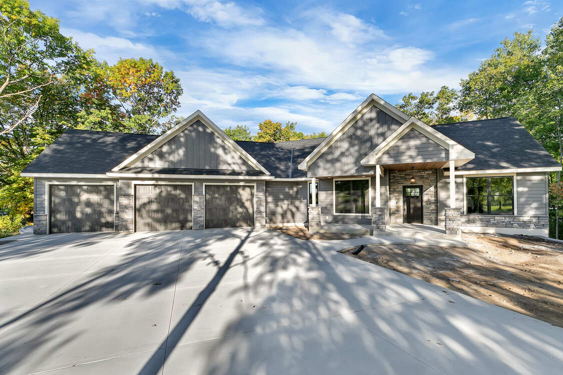 A large house is being built with a lot of trees in the background.