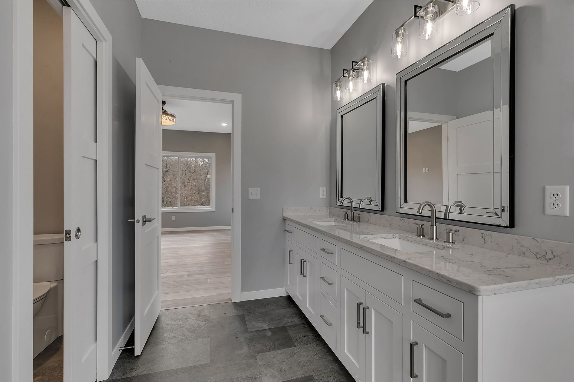 A bathroom with two sinks and two mirrors.