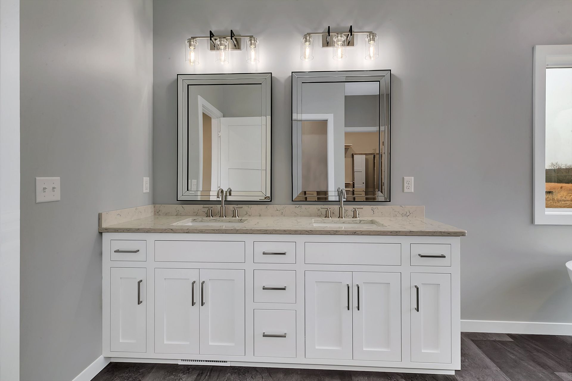 A bathroom with two sinks and two mirrors.