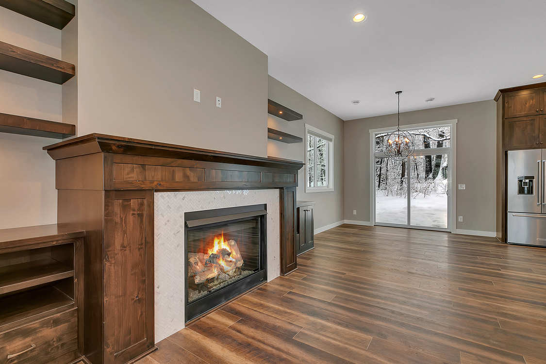 There is a fireplace in the middle of the living room.
