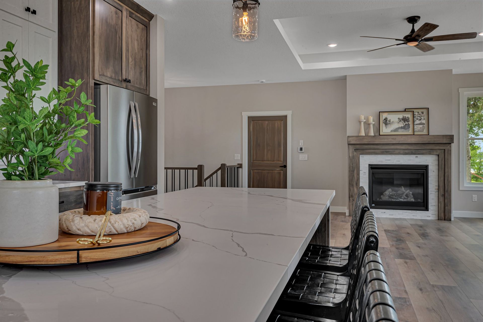 A kitchen with a large island and a fireplace.