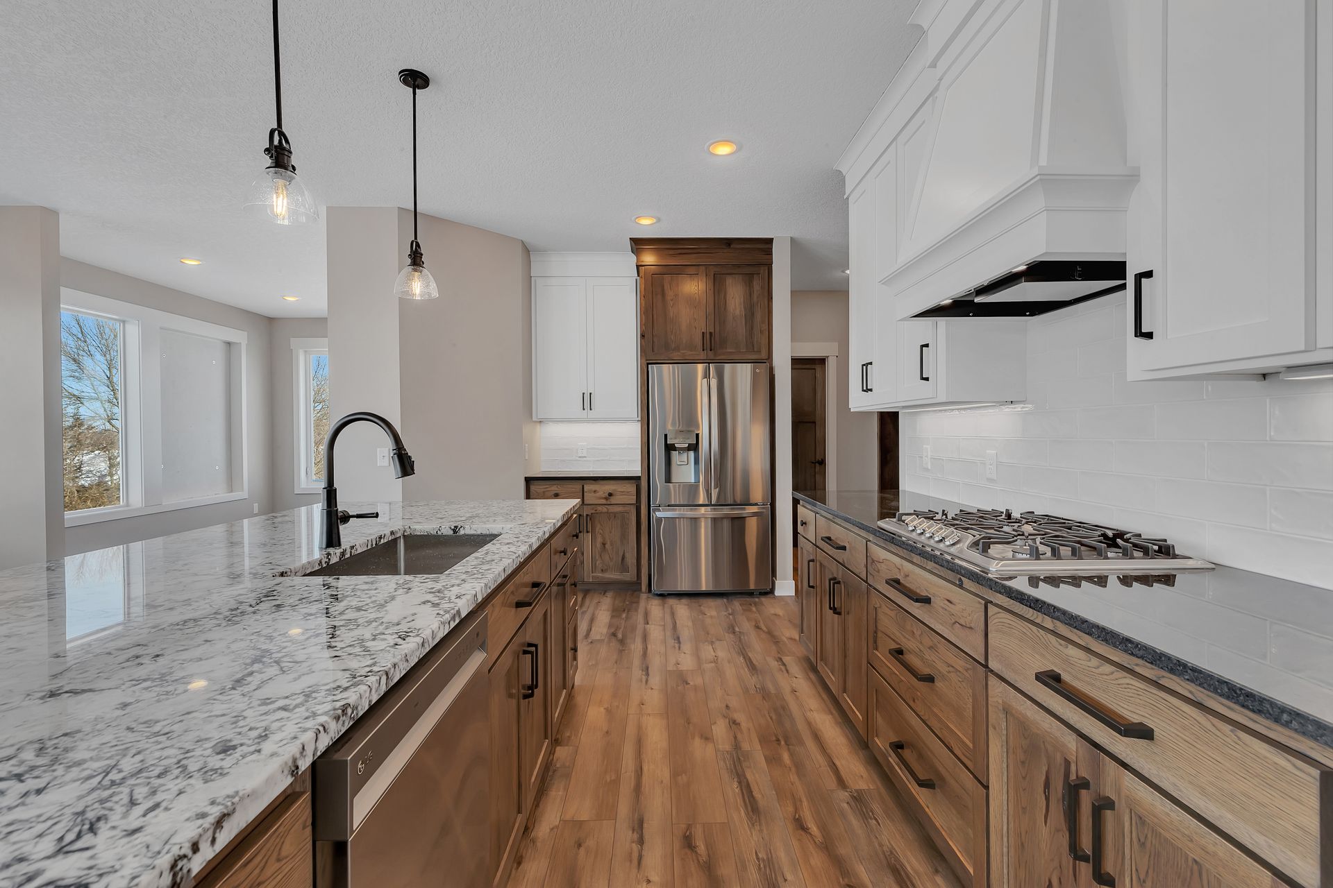 A kitchen with stainless steel appliances and granite counter tops.