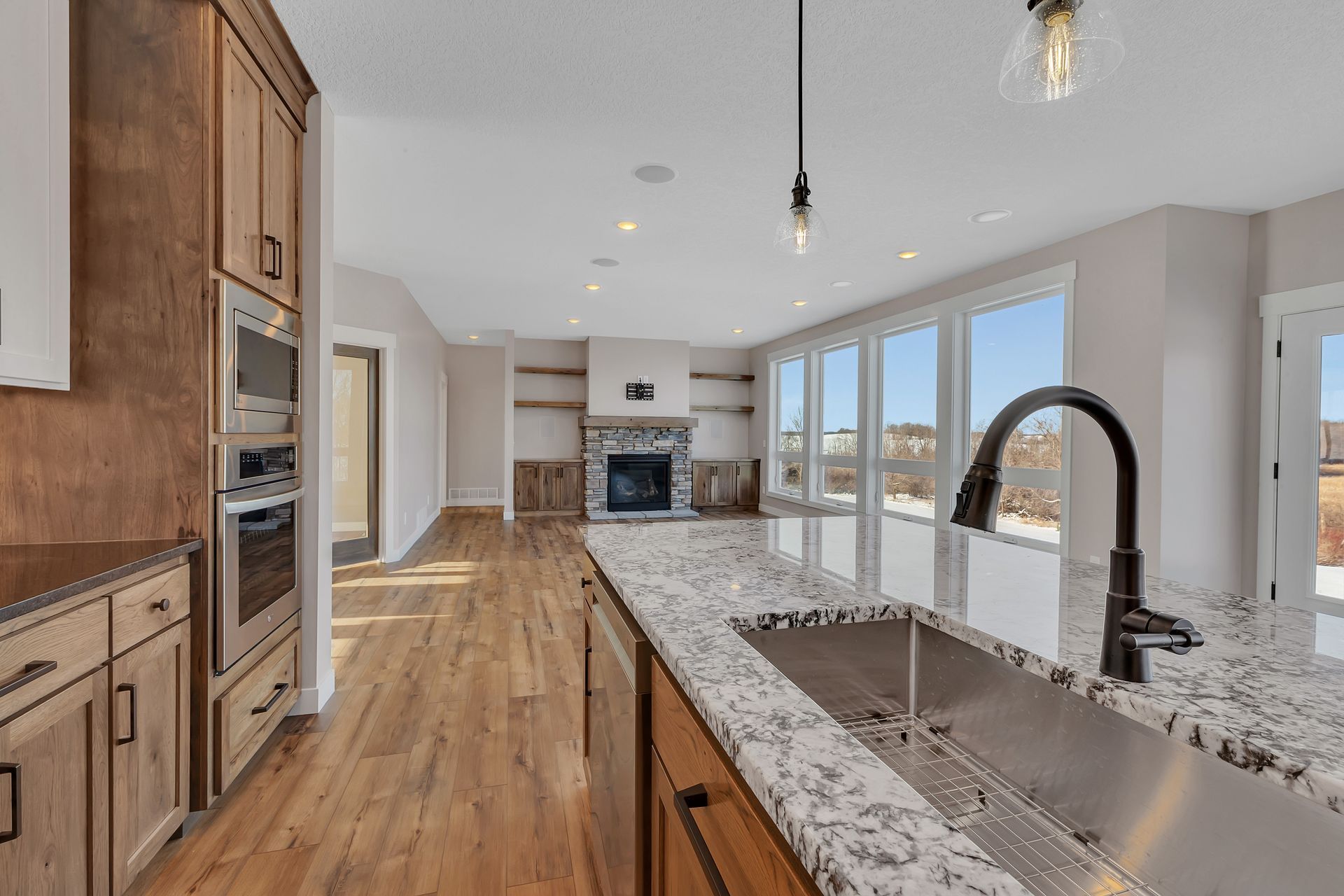 A kitchen with a stainless steel sink and granite counter tops.