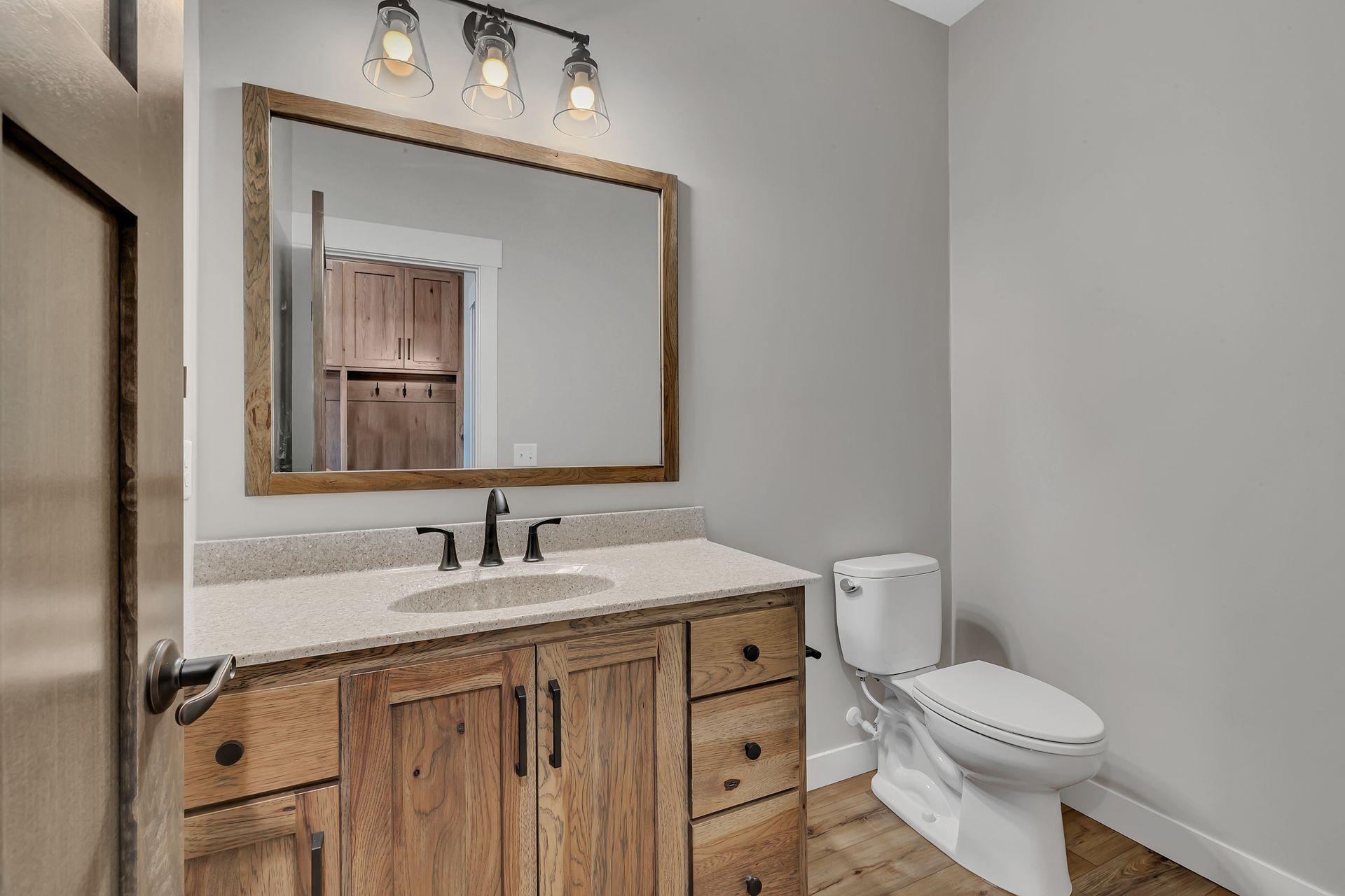 A bathroom with a sink , toilet and mirror.