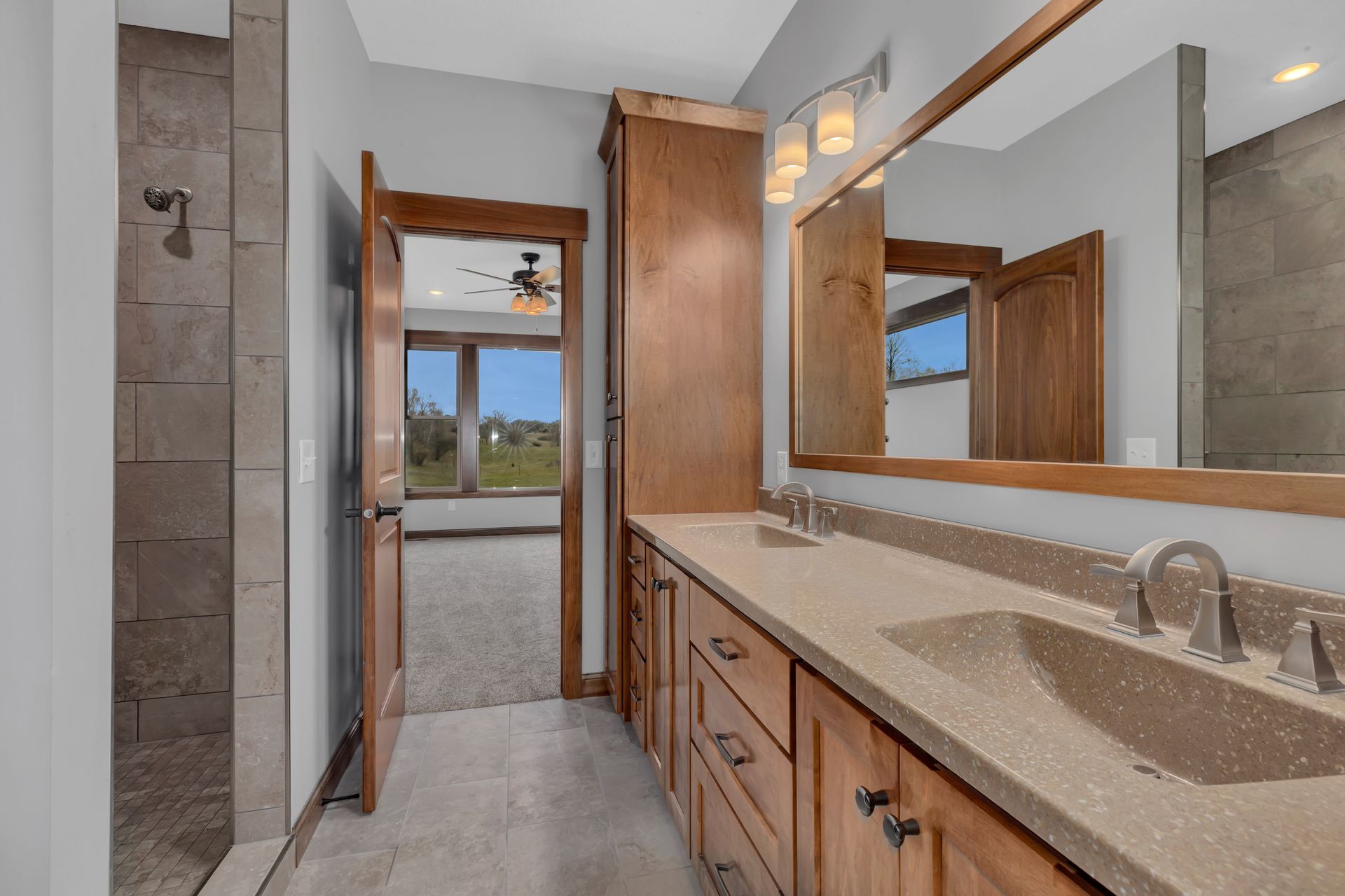 A bathroom with two sinks and a large mirror
