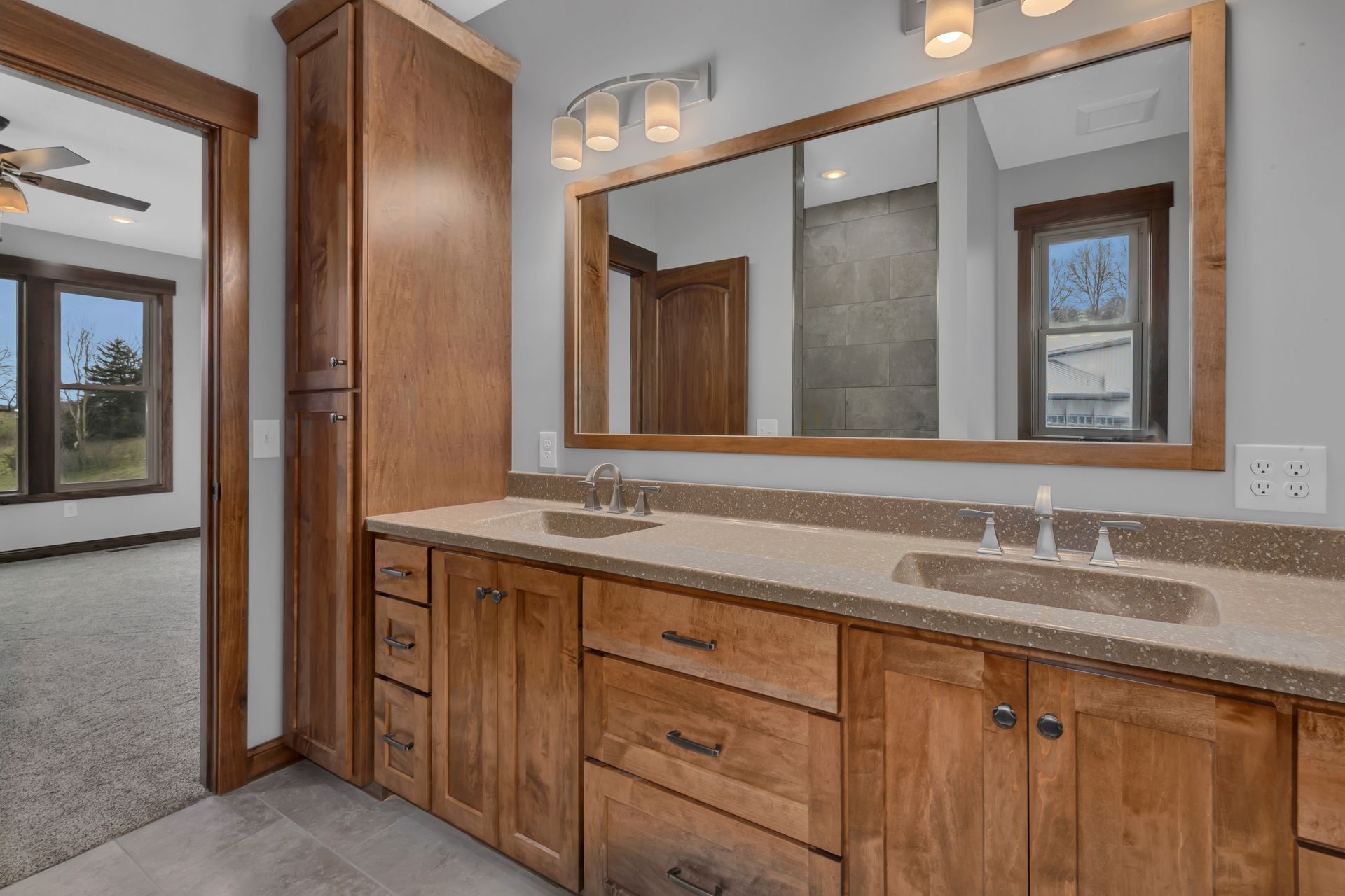 A bathroom with two sinks and a large mirror.