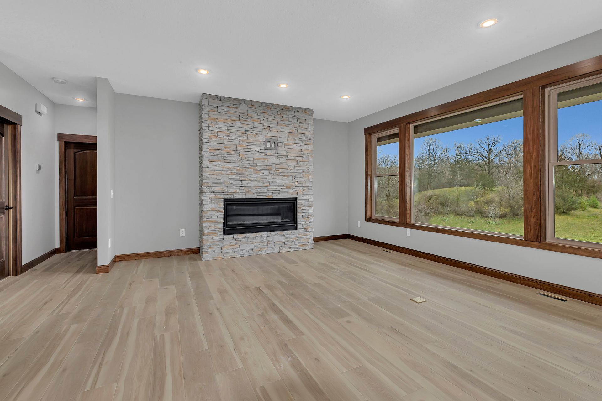 There is a fireplace in the middle of the living room.
