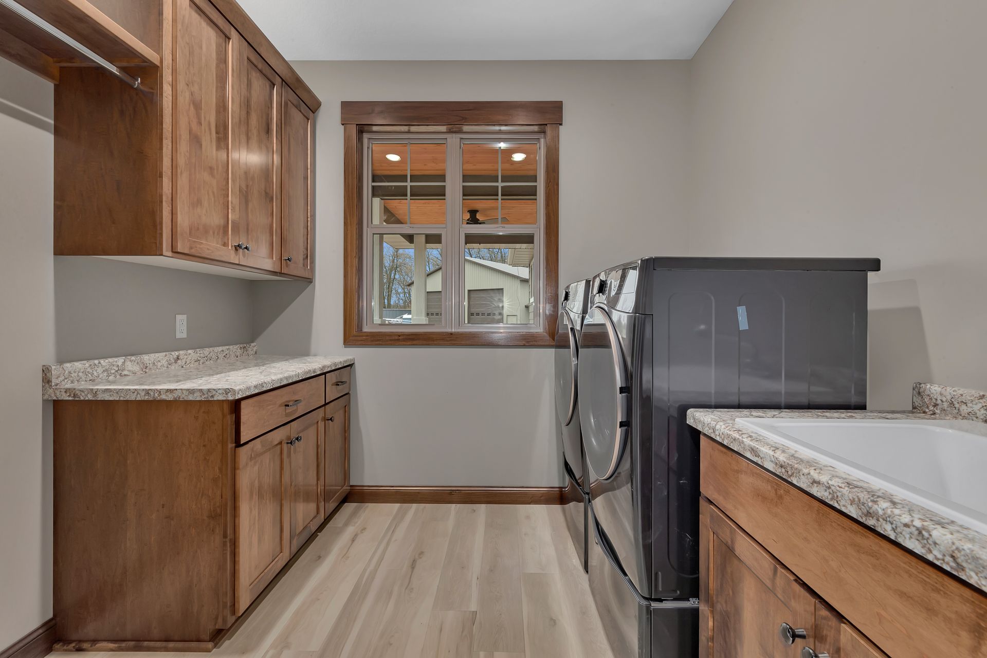 A laundry room with a washer and dryer and a sink.