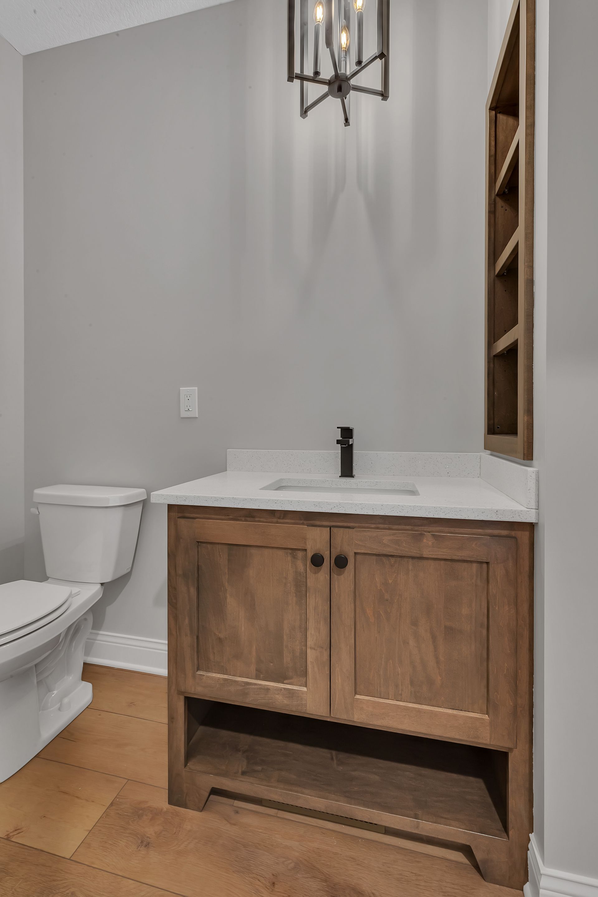 A bathroom with a toilet , sink , and mirror.