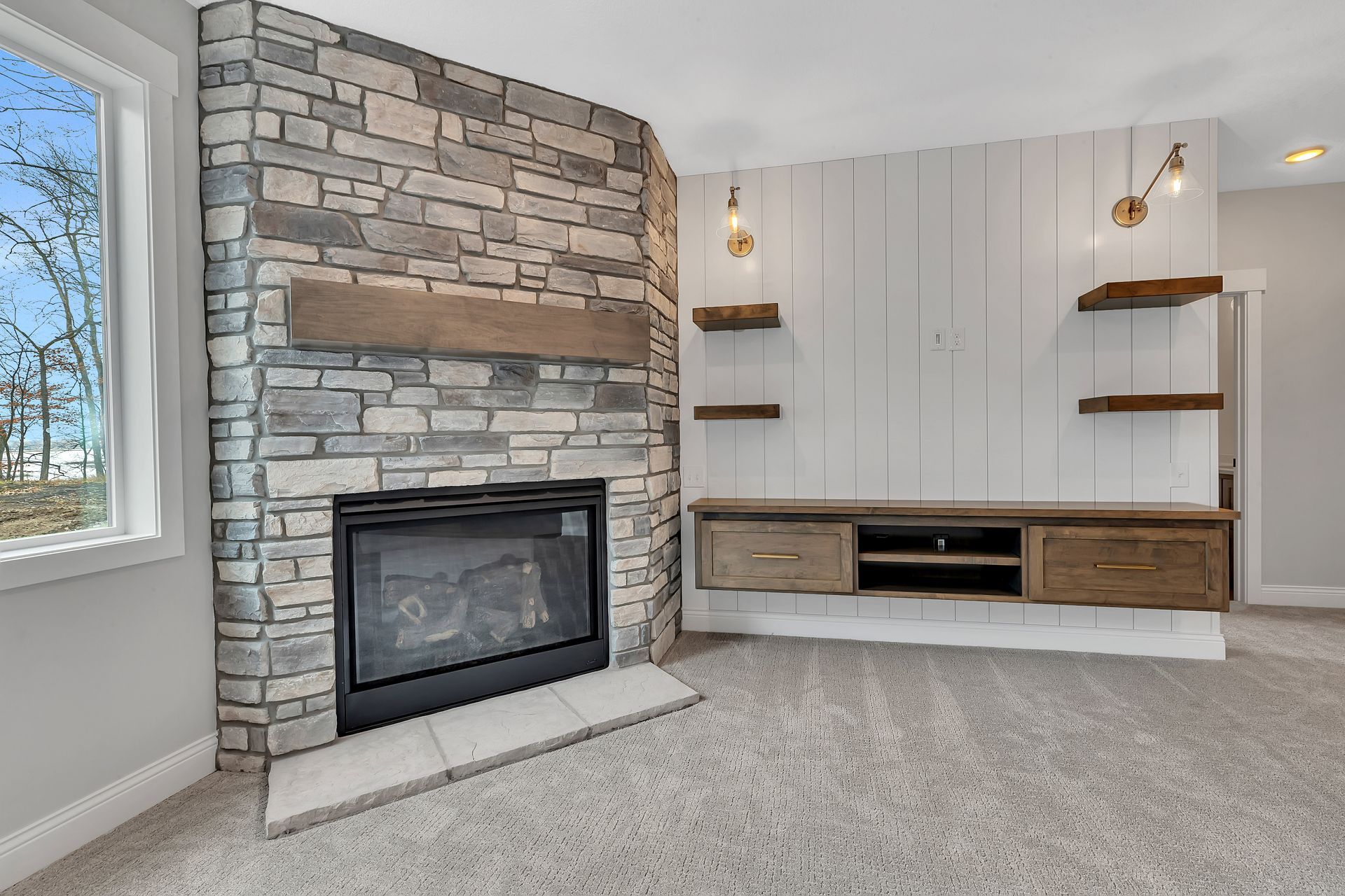 A living room with a fireplace and a window