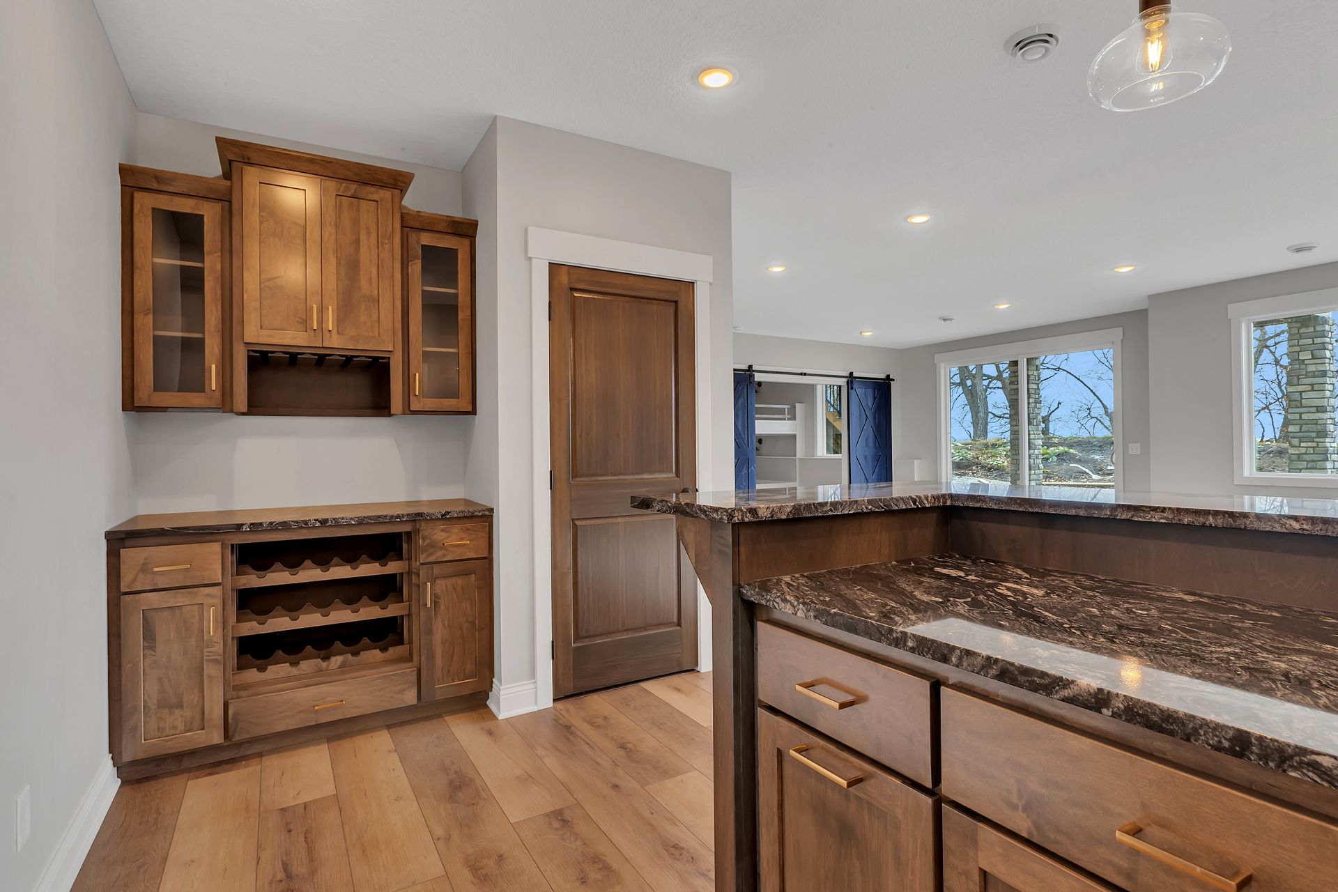 A kitchen with wooden cabinets and granite counter tops.