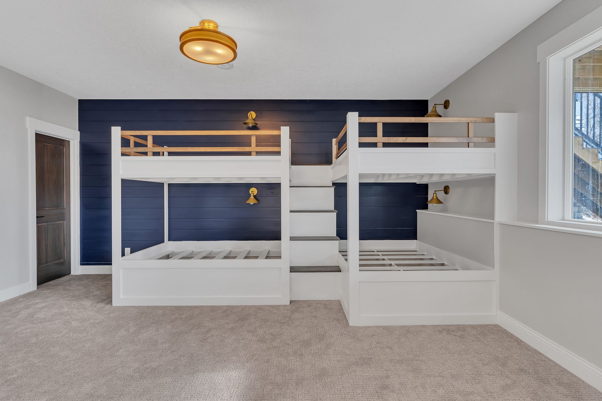 A bedroom with two bunk beds and a blue wall.