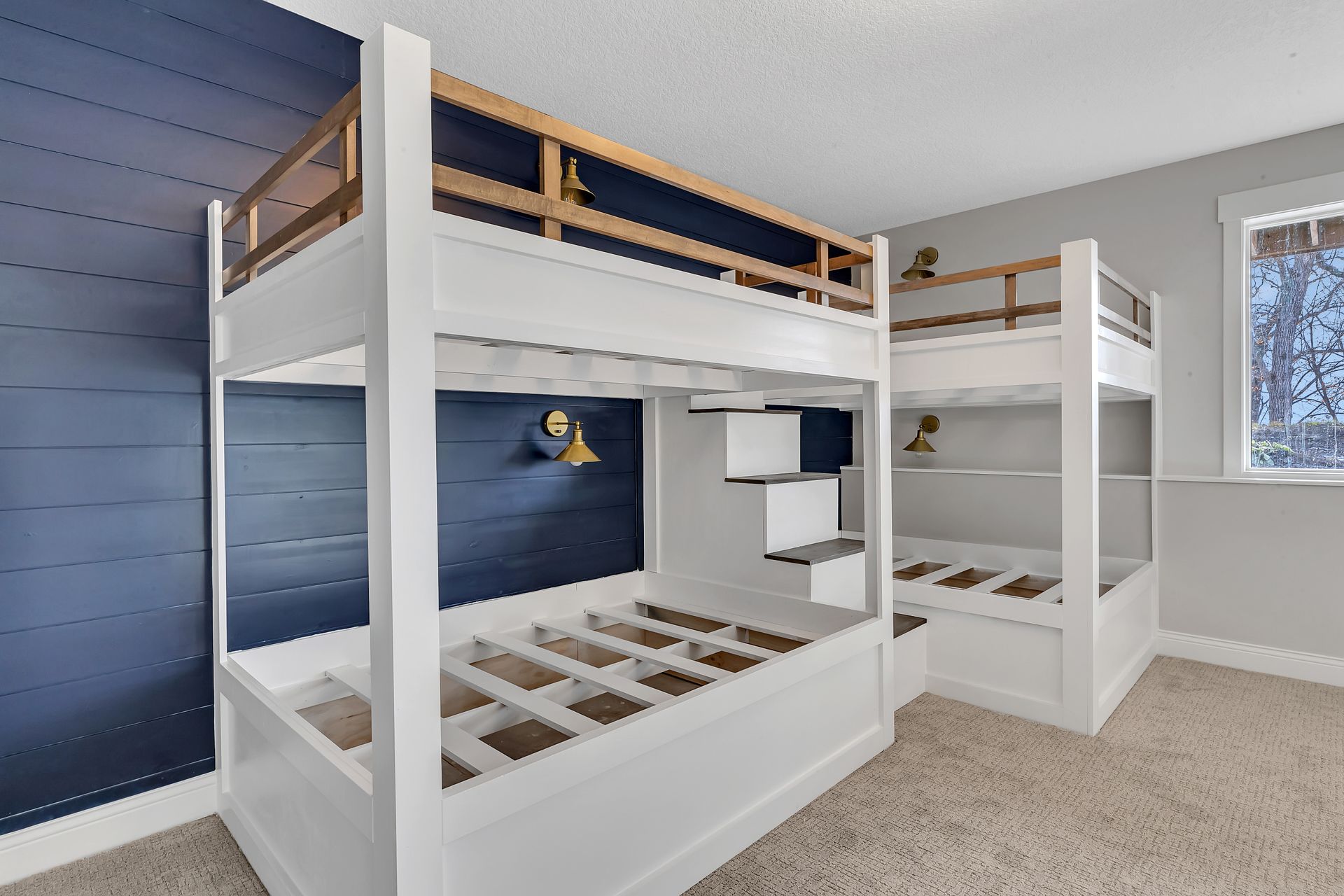 A bedroom with two bunk beds and a window.