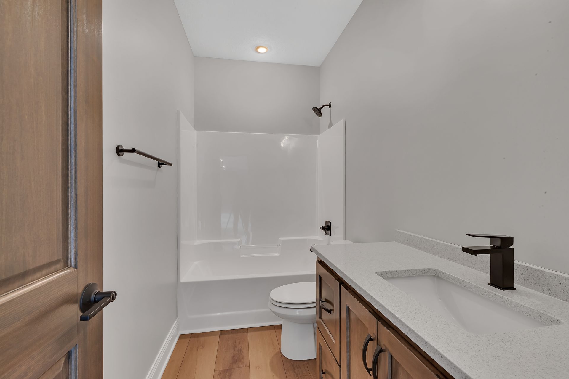 A bathroom with a toilet , sink , and shower.