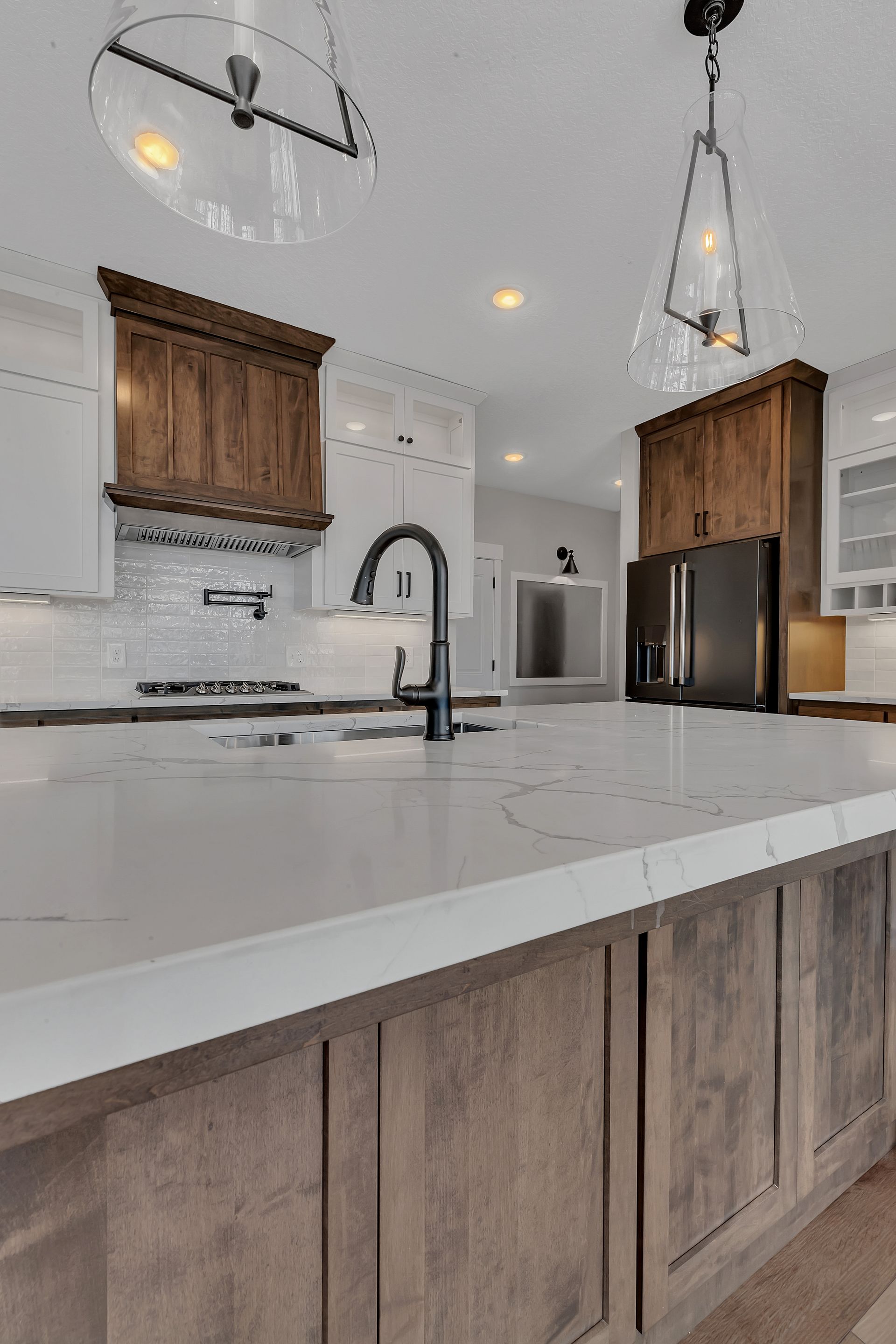 A kitchen with wooden cabinets and a white counter top.
