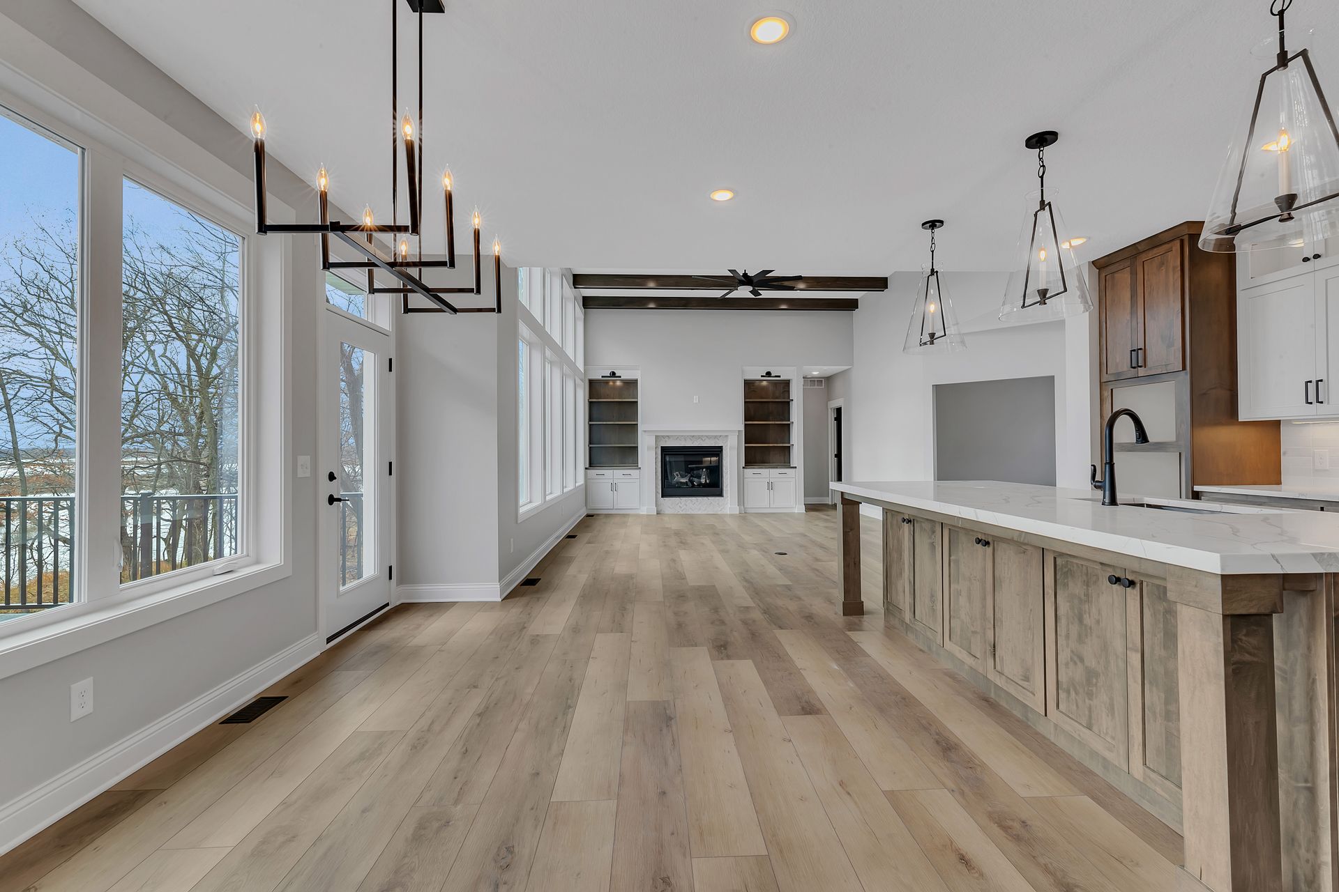 A kitchen with a large island and lots of windows