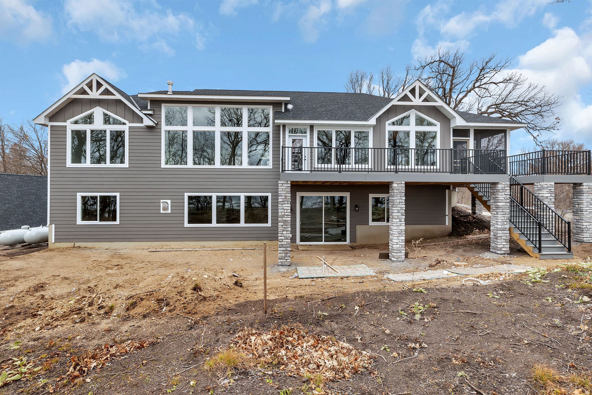 A large house with a lot of windows and a large deck.