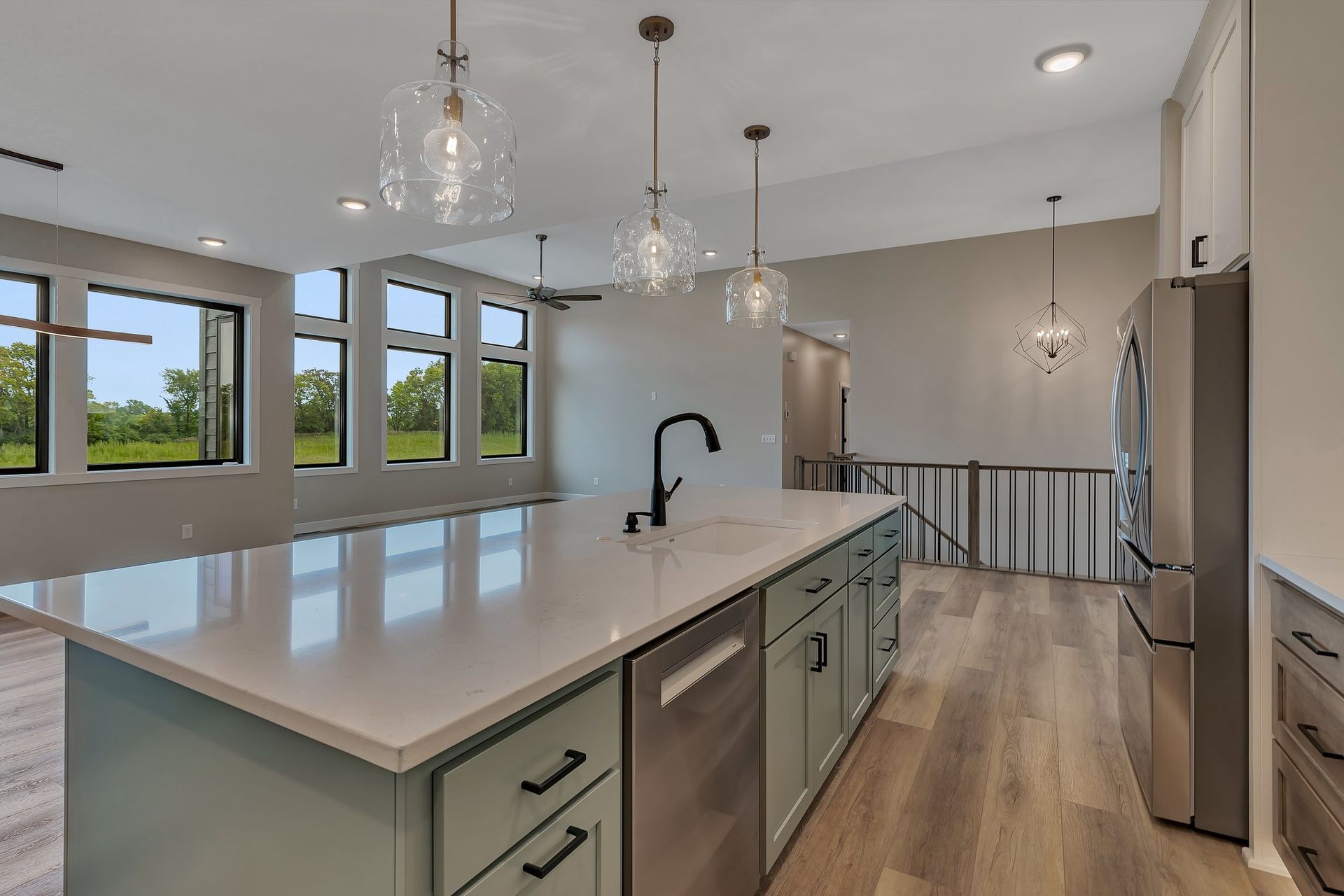 A kitchen with a large island and stainless steel appliances.