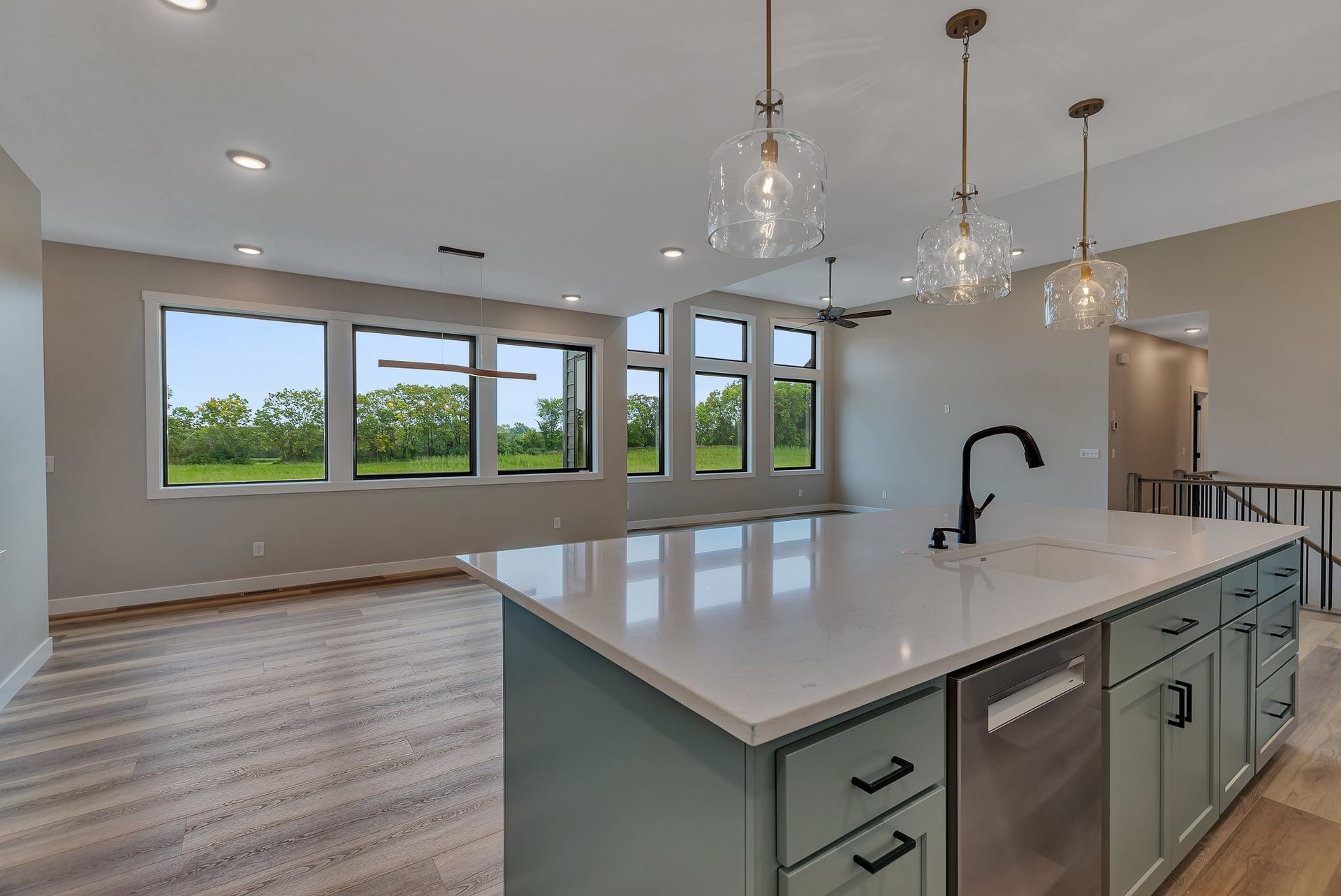 A kitchen with a large island and stainless steel appliances.