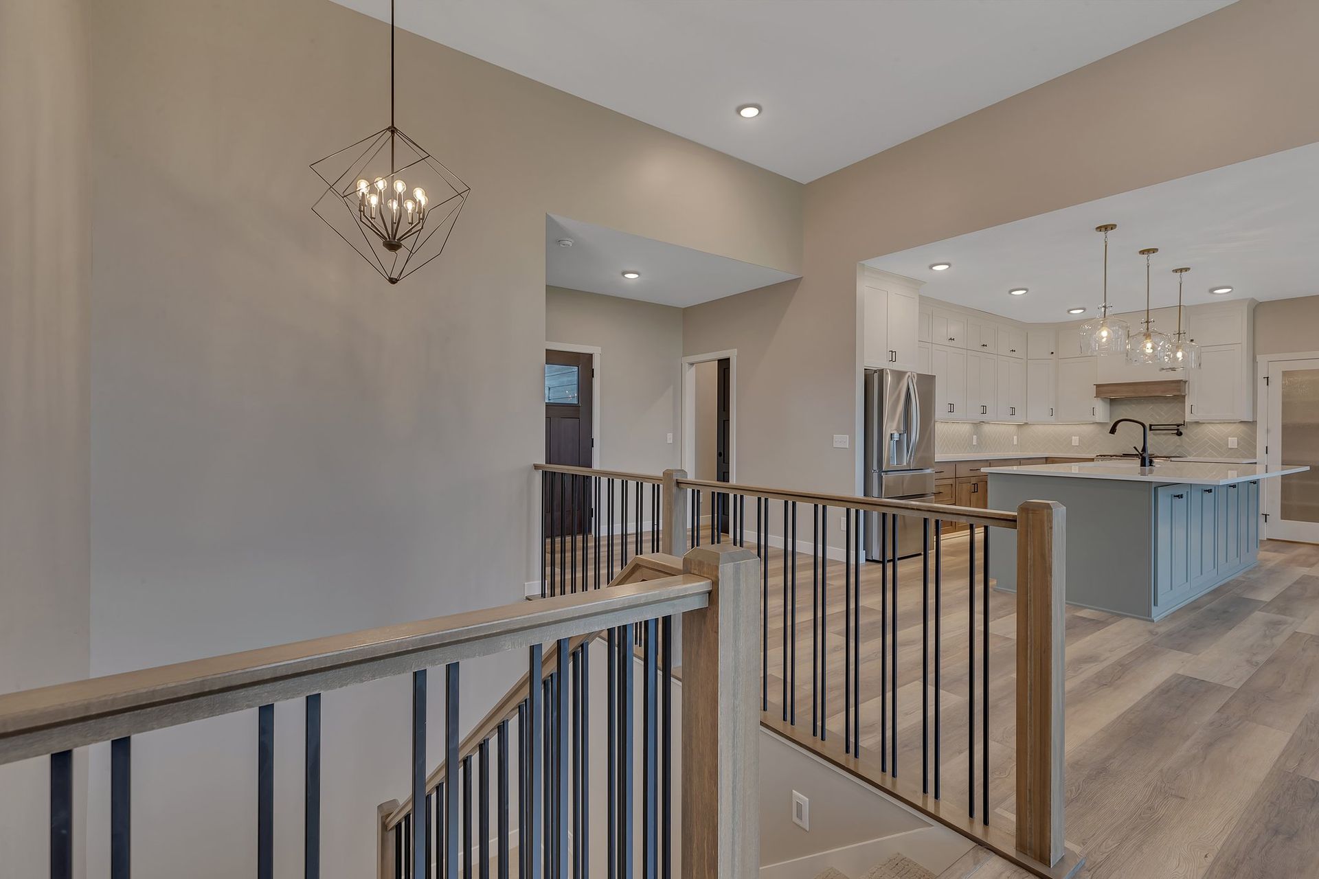 A staircase leading up to a kitchen in a house.