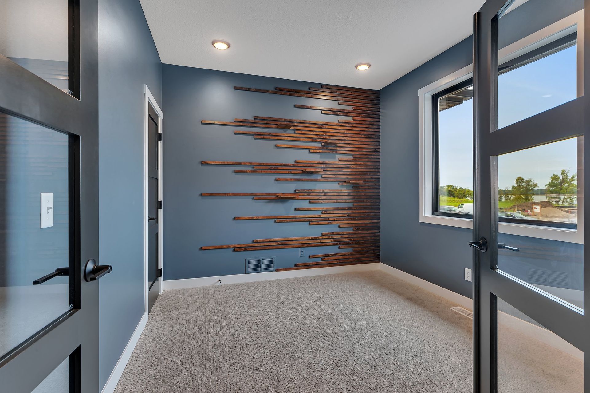 A room with blue walls and a wooden wall decoration.