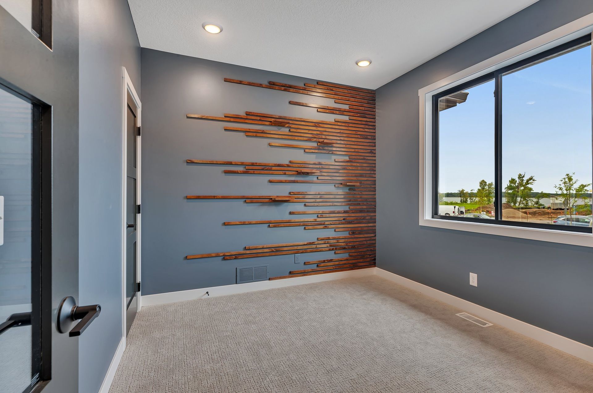 An empty room with a wooden wall and a window