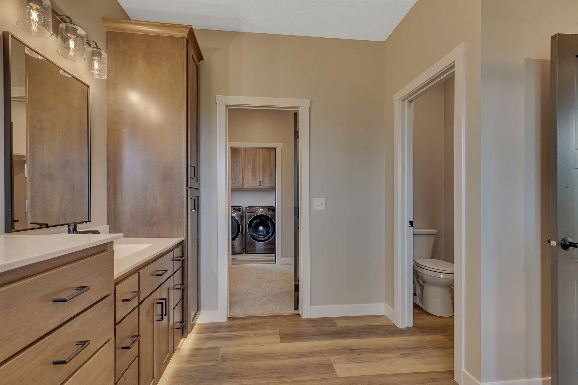 A bathroom with a sink , mirror , and toilet.