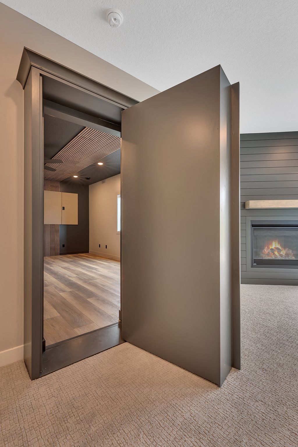 A door that is open in a room with a fireplace.