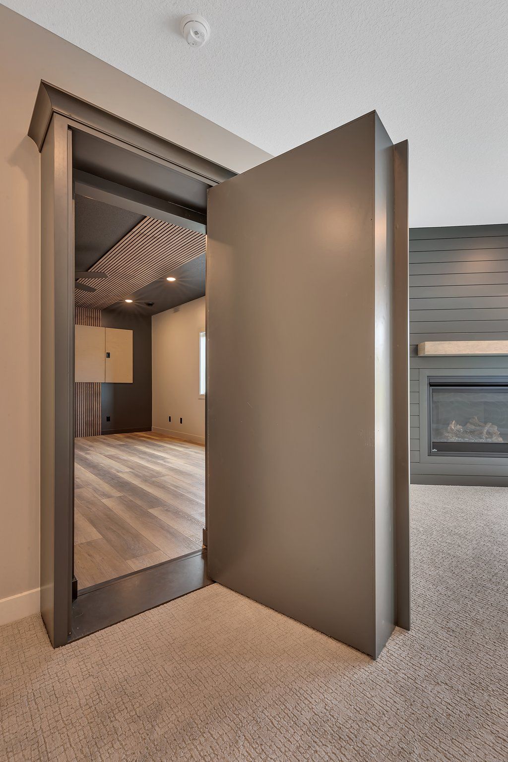 A door that is open in a room with a fireplace.