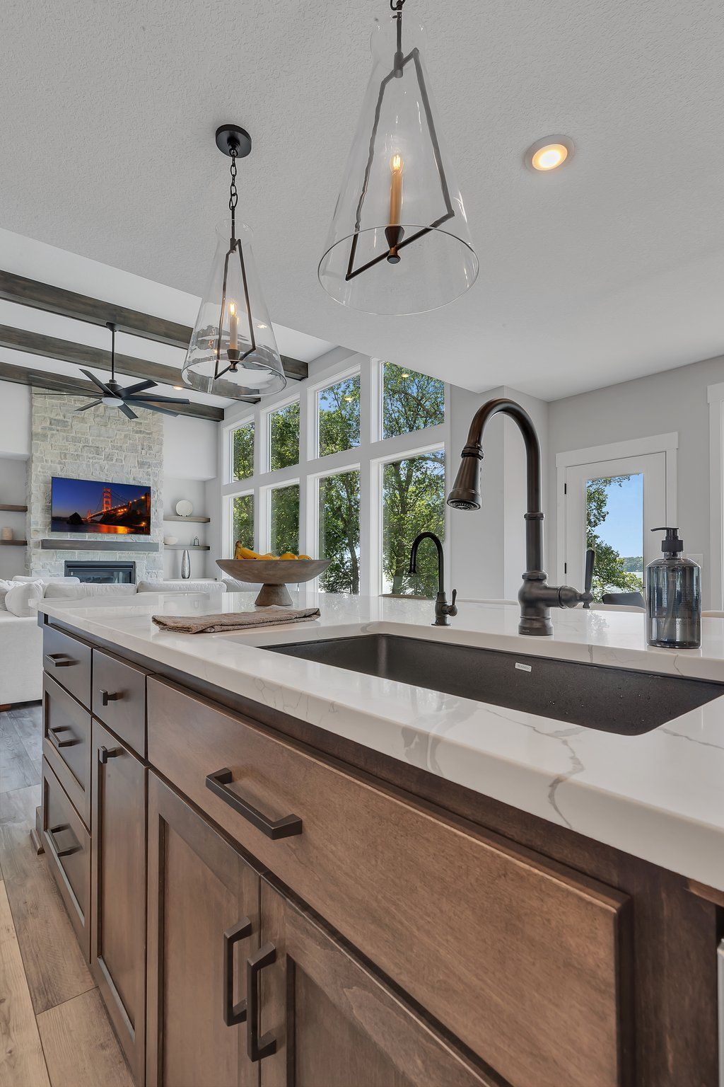 A kitchen with a sink , cabinets , and a faucet.