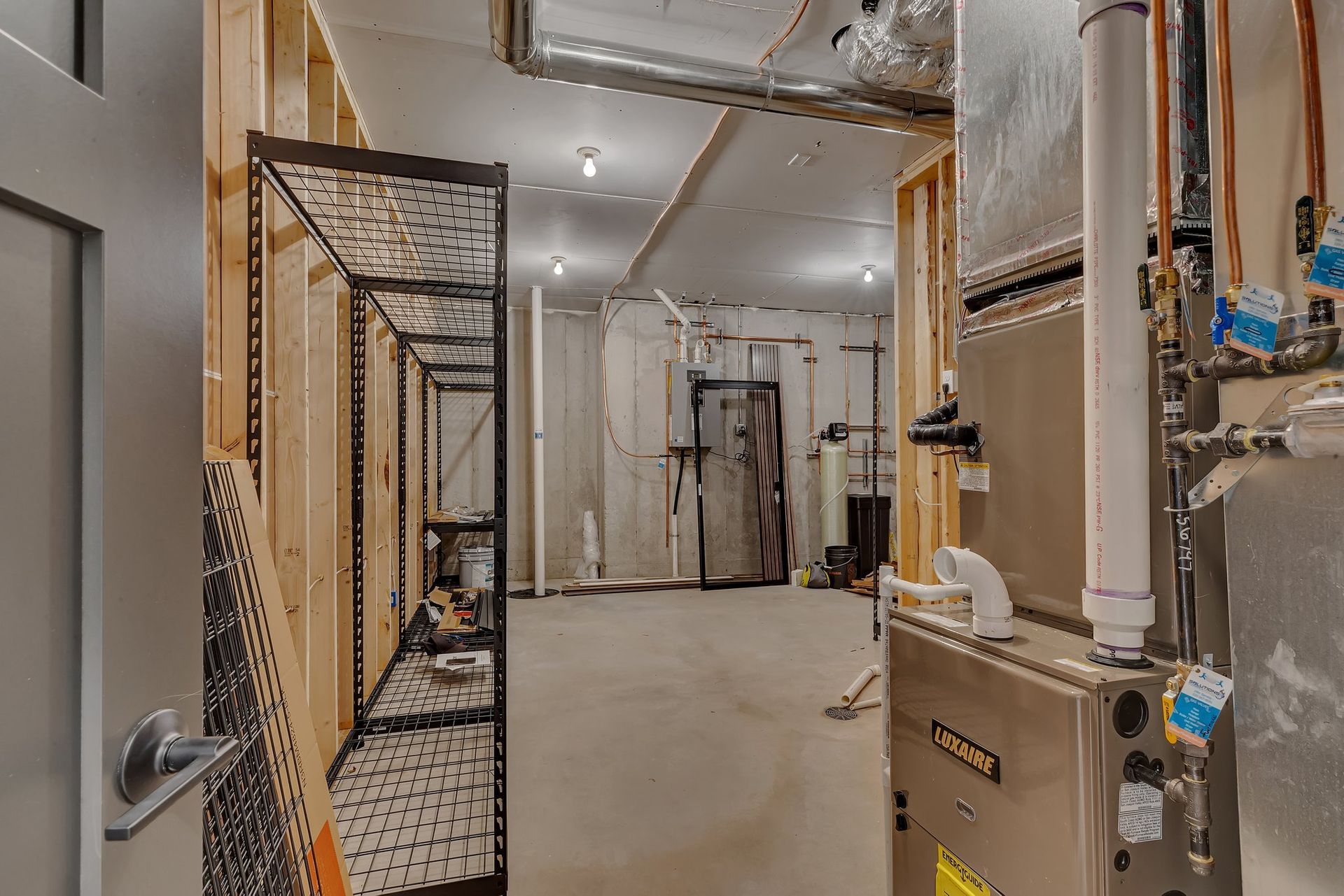 A basement with a furnace and a heater in it.