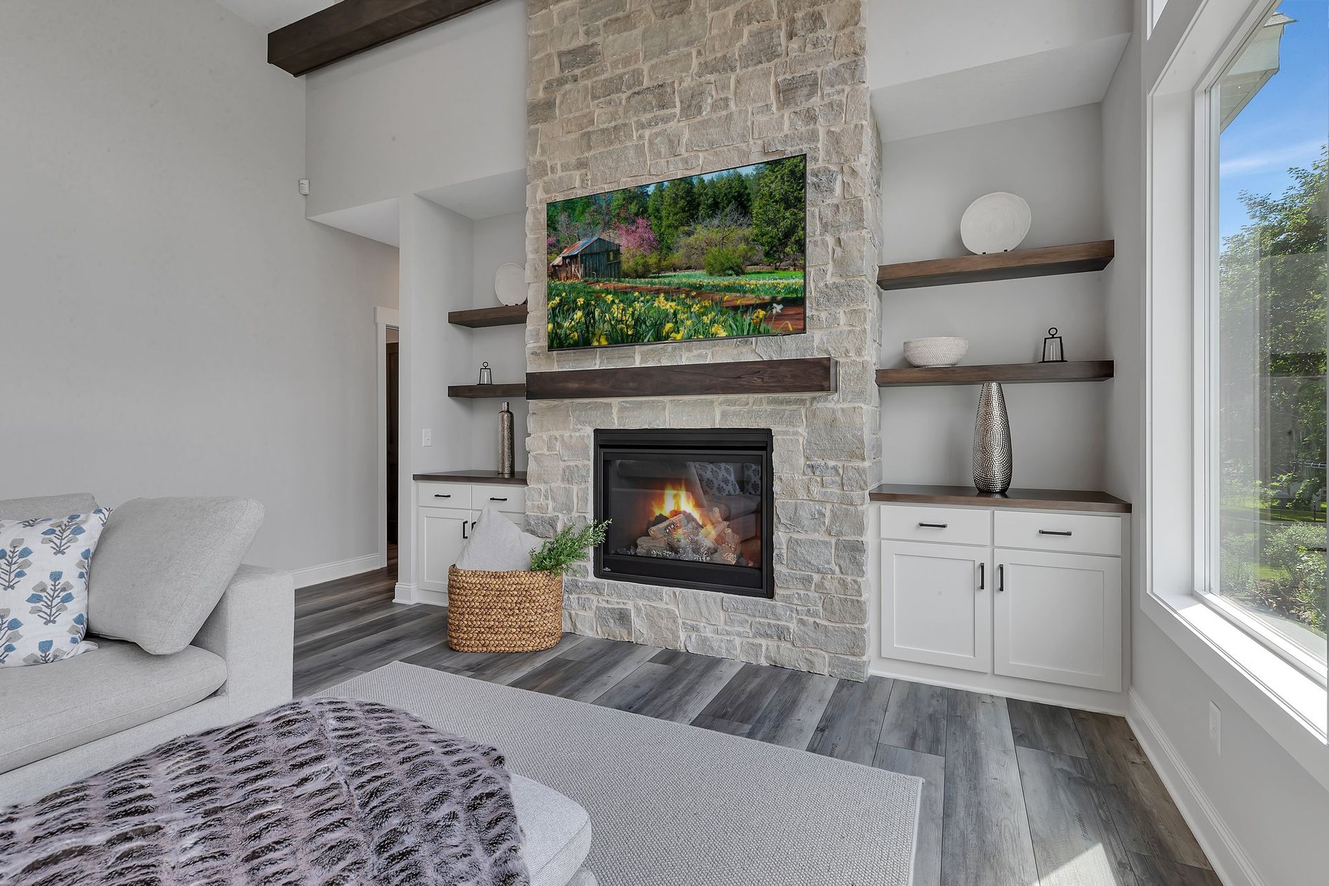 A living room with a fireplace , couch , and television.
