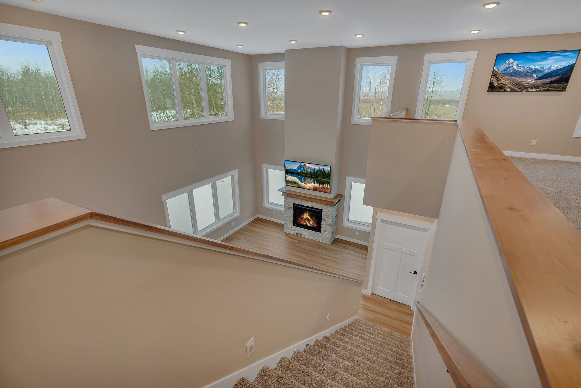A living room with a fireplace and stairs leading up to it.