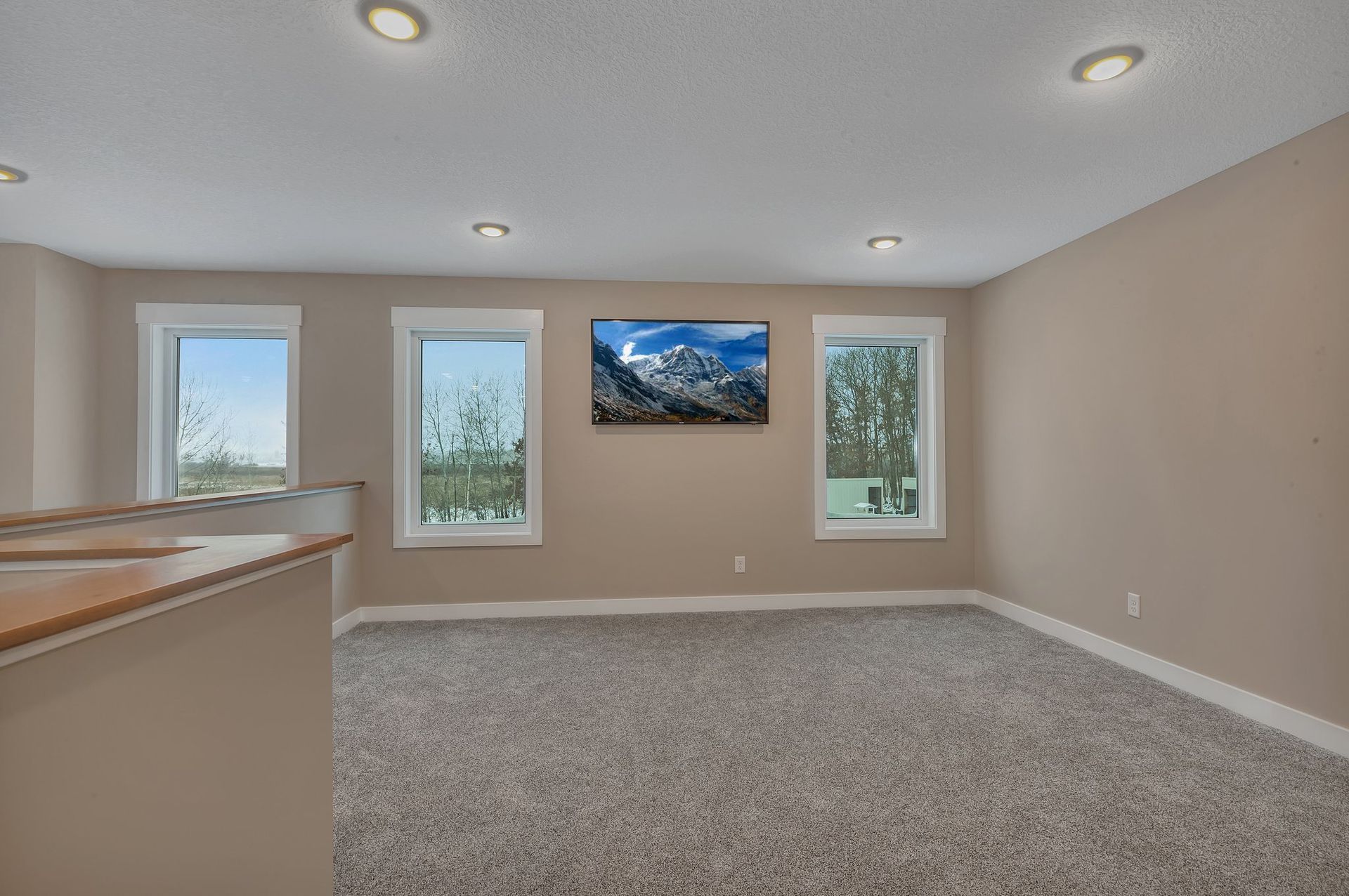 A living room with a flat screen tv on the wall.