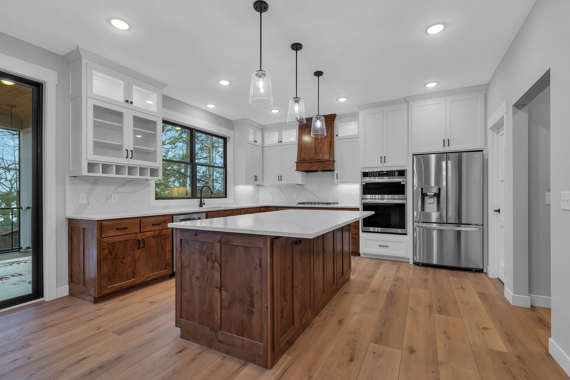 A kitchen with stainless steel appliances , wooden cabinets , and a large island.