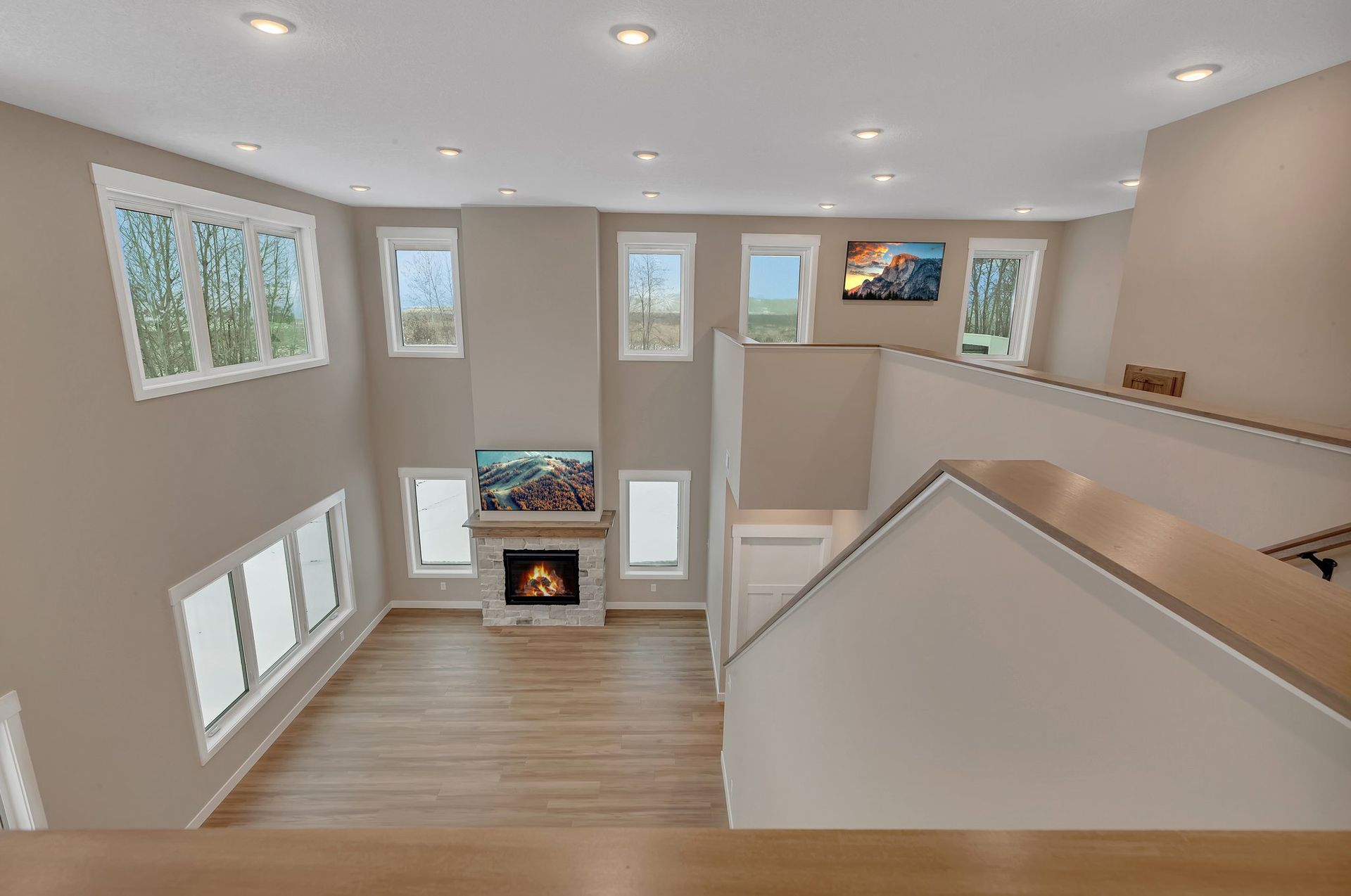 An aerial view of a living room with a fireplace and stairs.