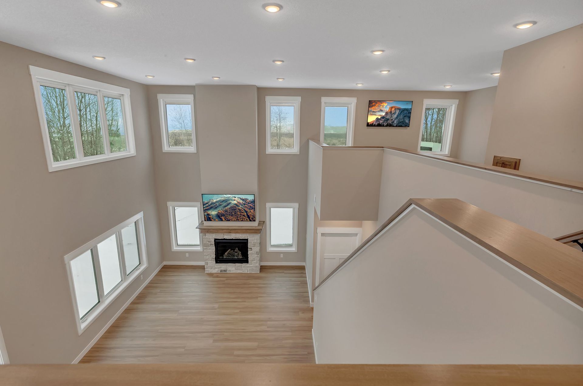 An aerial view of a living room with a fireplace and stairs.