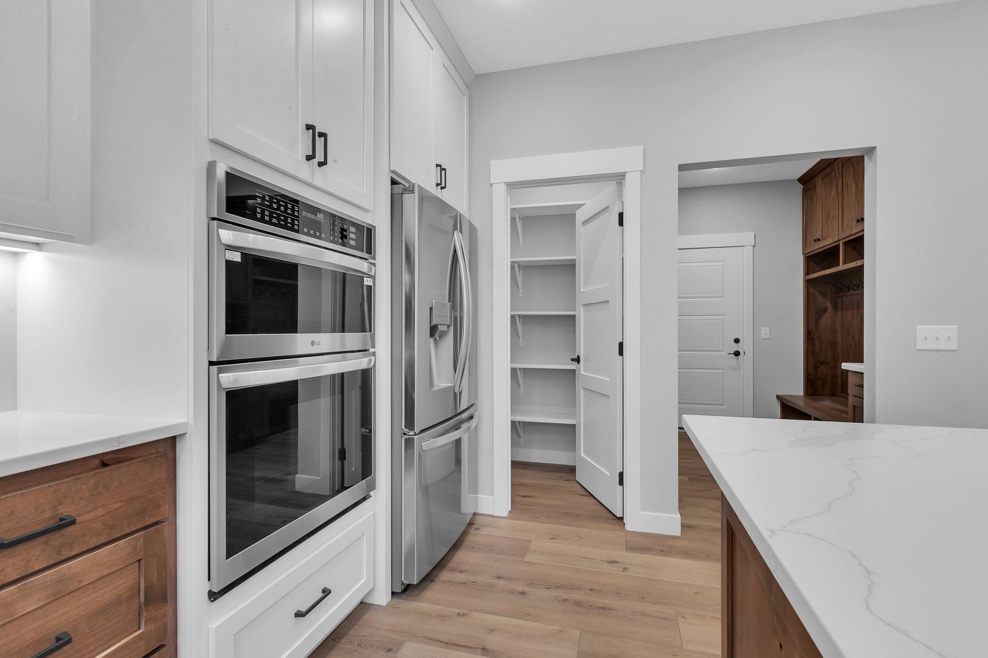 A kitchen with stainless steel appliances and wooden cabinets.