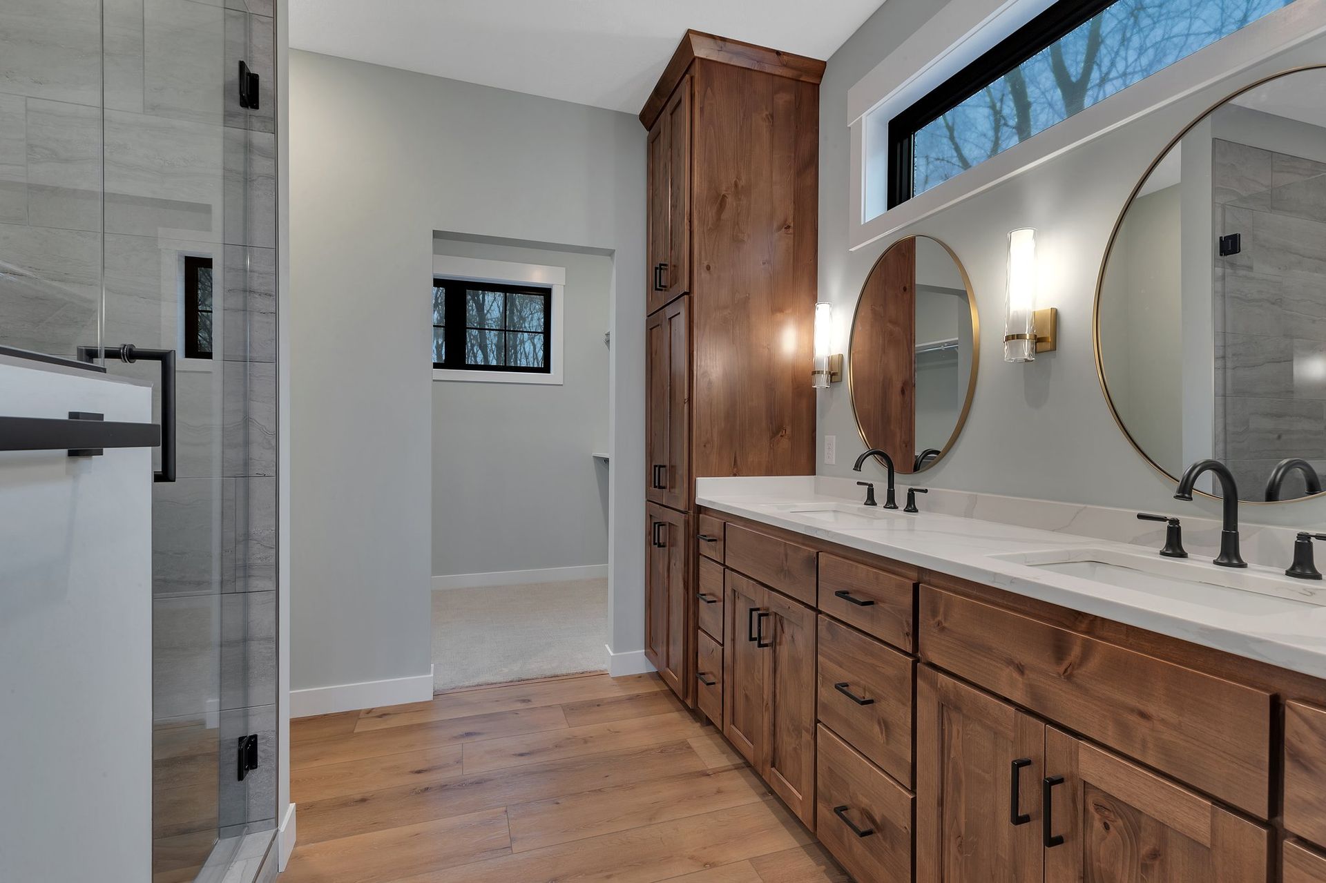 A bathroom with two sinks and two mirrors.